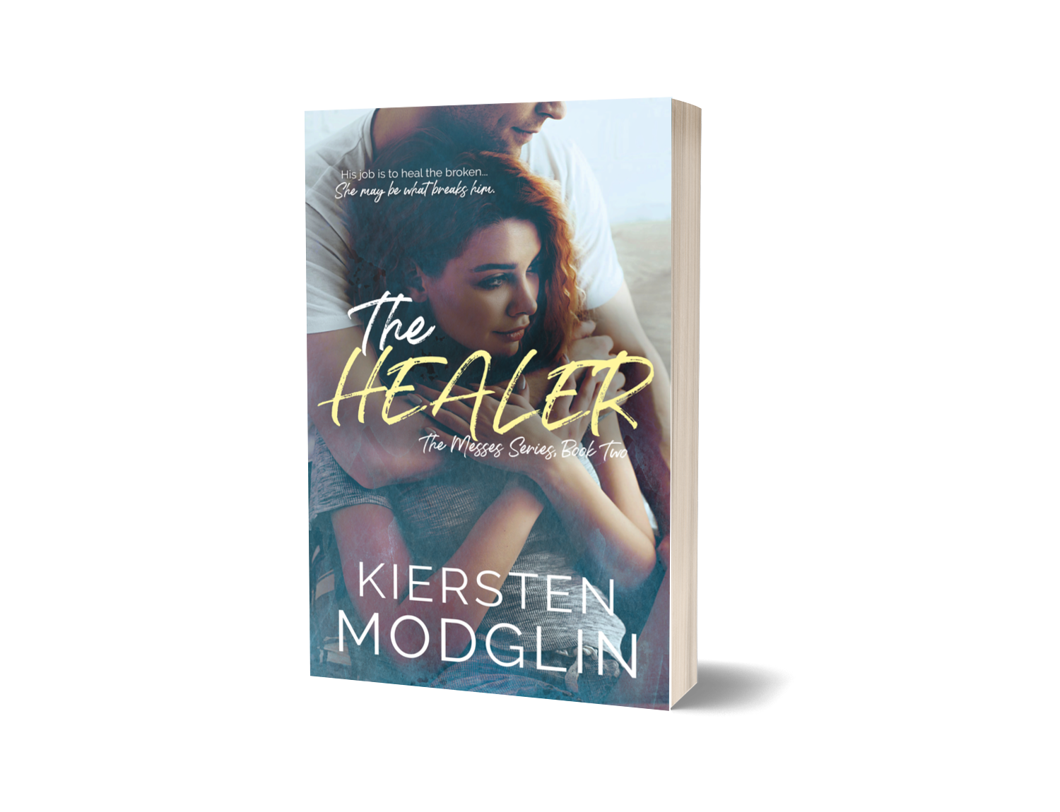 Book cover of "The Healer" by Kiersten Modglin. Features a woman with red hair being embraced by a man, with a soft, blurred background.