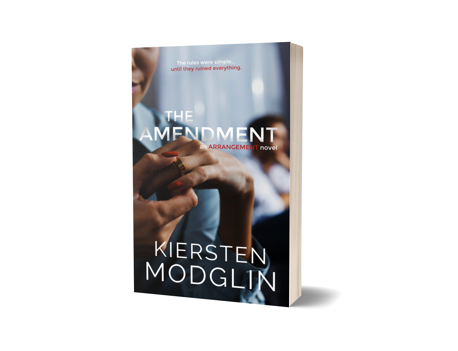 Book titled "The Amendment" by Kiersten Modglin, with a cover photo of a woman's hands holding a man's hand and a blurred background of people.