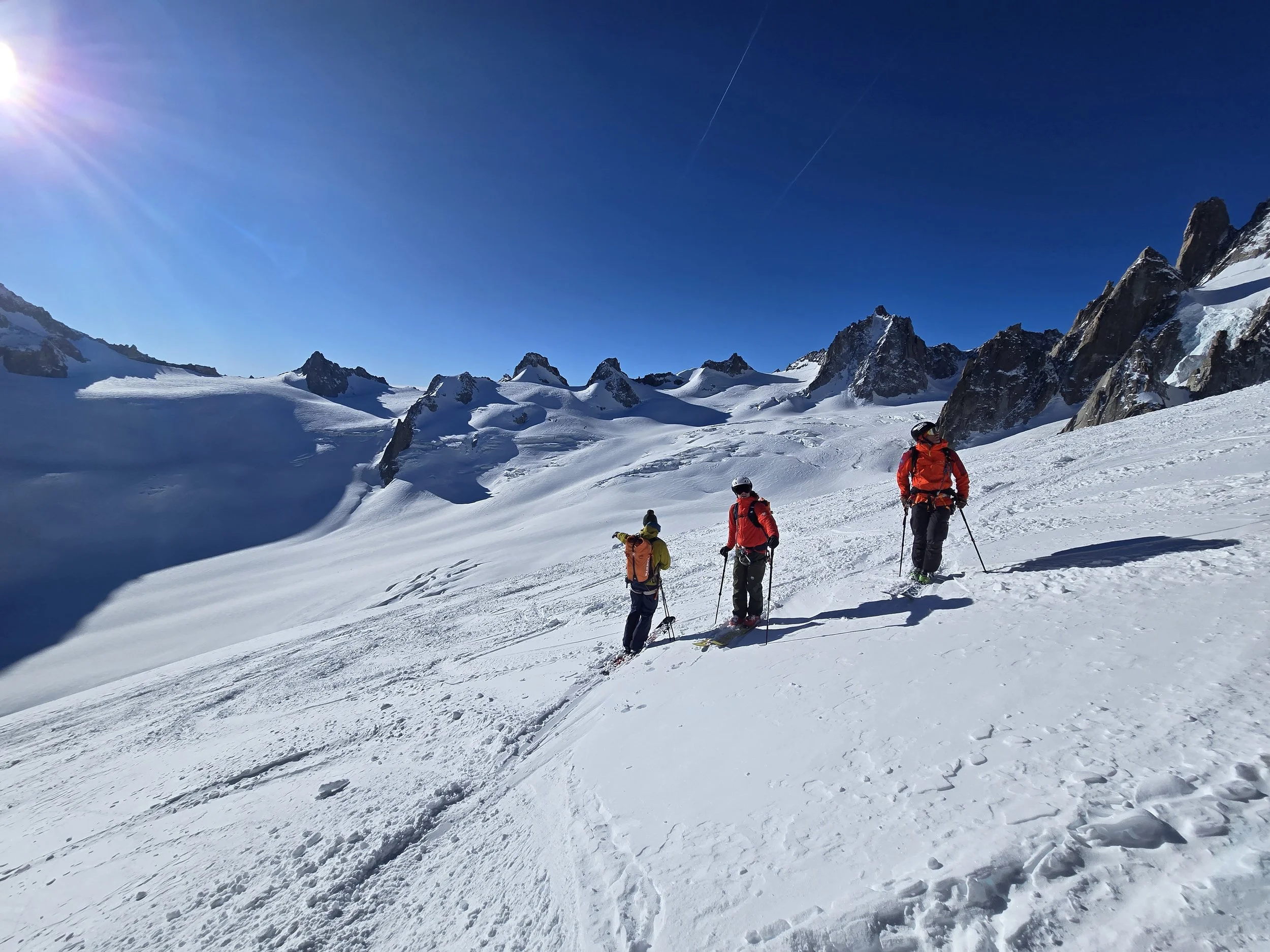 Skiers crossing a glacier on a guided ski tour in Switzerland