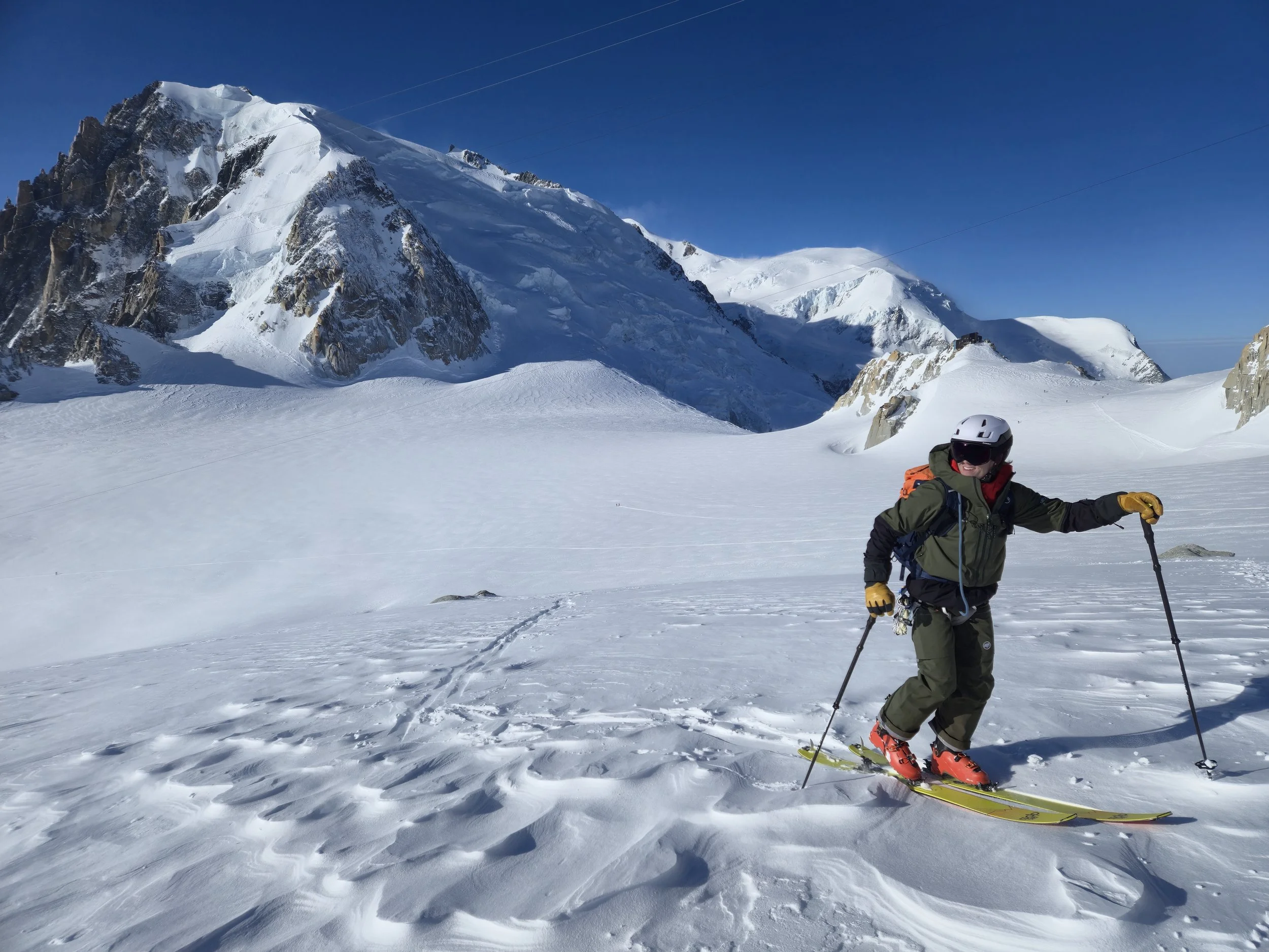 Skier skinning toward a high pass on a Berner Oberland ski tour