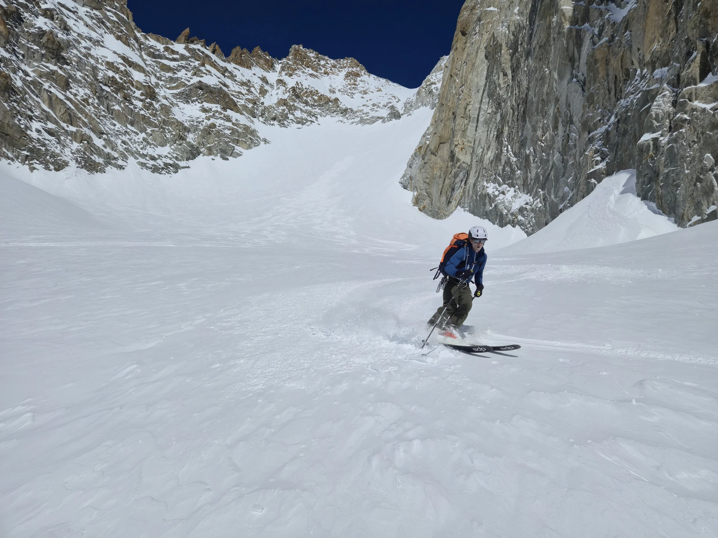 Skier descending powder during a guided Berner Oberland ski tour