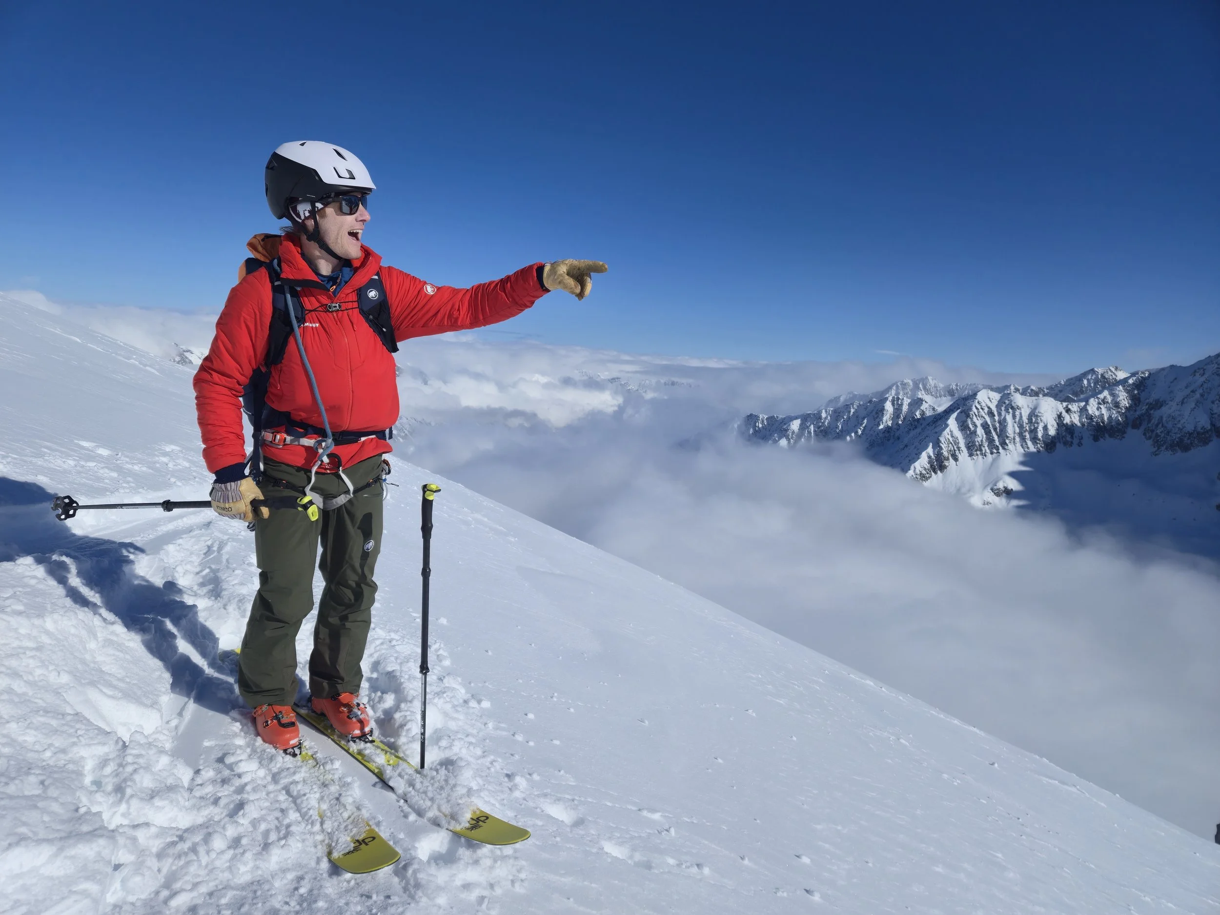 Skier on a high pass on a guided Swiss Alps ski tour