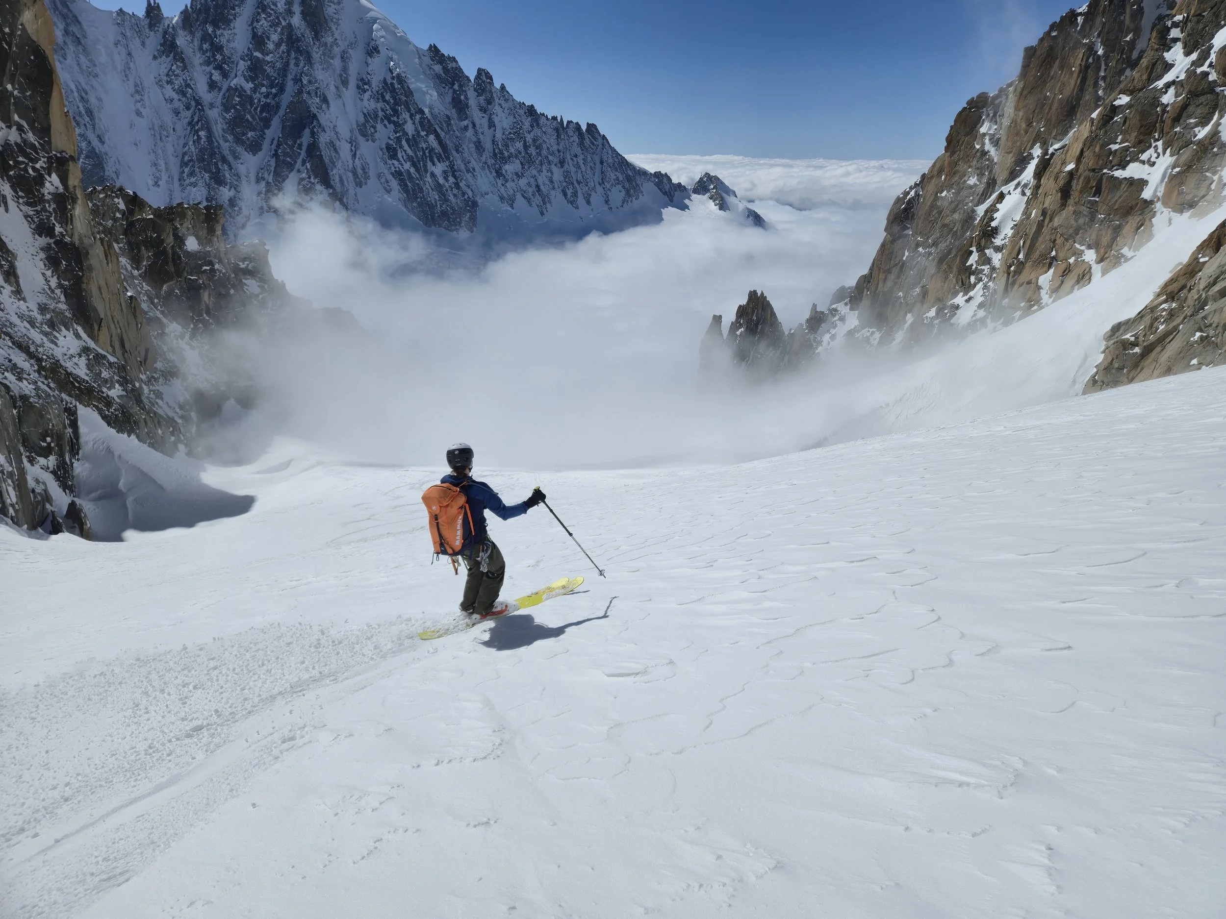 Skier enjoying powder skiing during a guided backcountry ski tour in New Hampshire's White Mountains