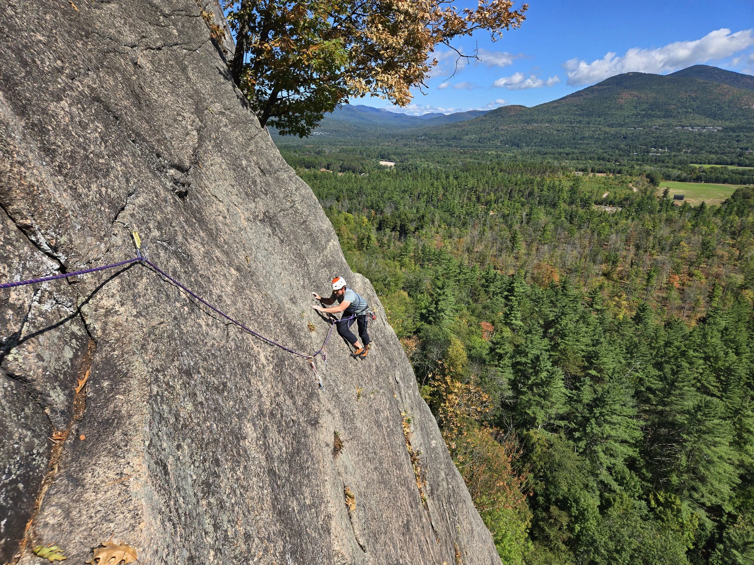 Climber following a guide on a multipitch route at Cathedral Ledge in North Conway NH during a guided climbing day