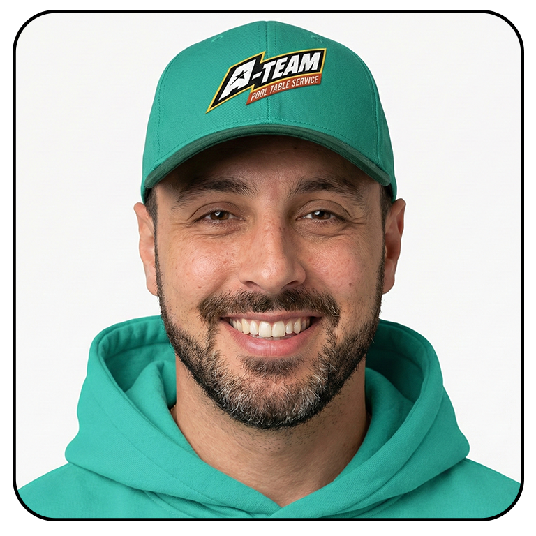 Man wearing a teal cap with a logo that says 'A-TEAM Pool Table Service' and a matching teal hoodie, smiling at the camera.