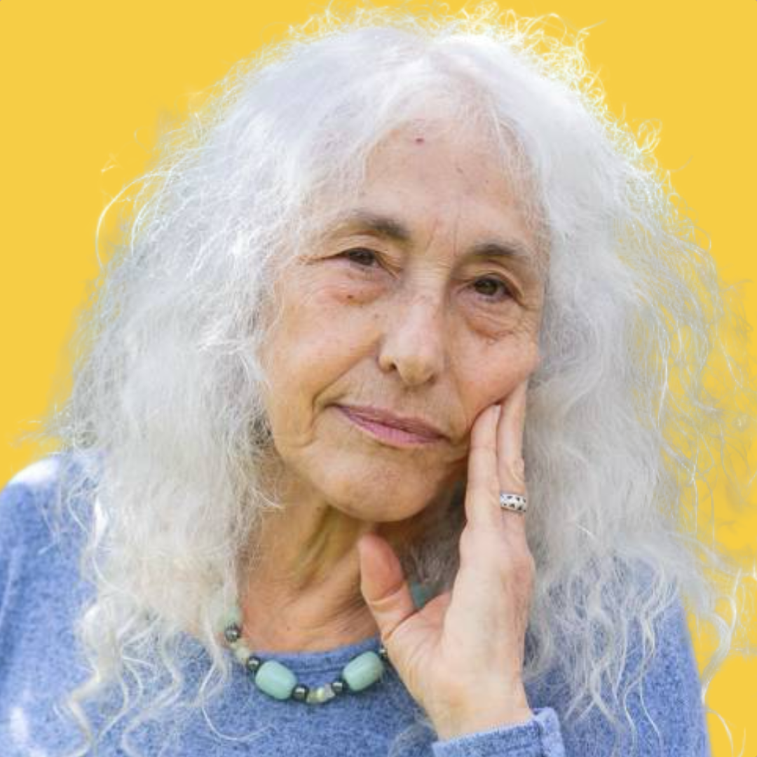 A portrait of an elderly woman with long white hair, wearing a blue top, a beaded necklace, and a ring, resting her face on her hand against a yellow background.