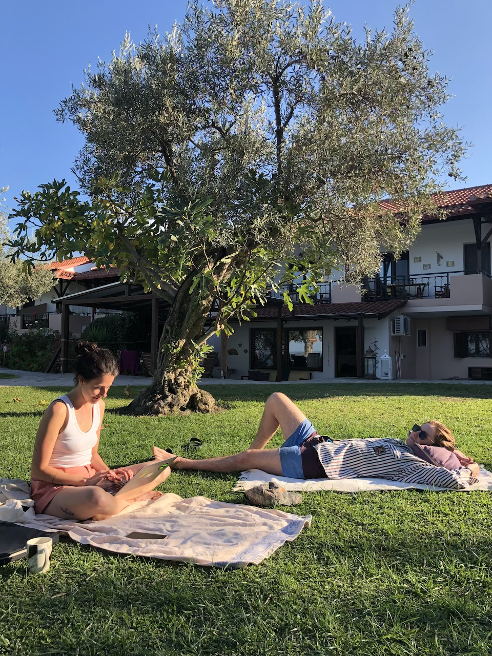 Writers enjoying the evening sunshine on site at a creative writing retreat in Greece