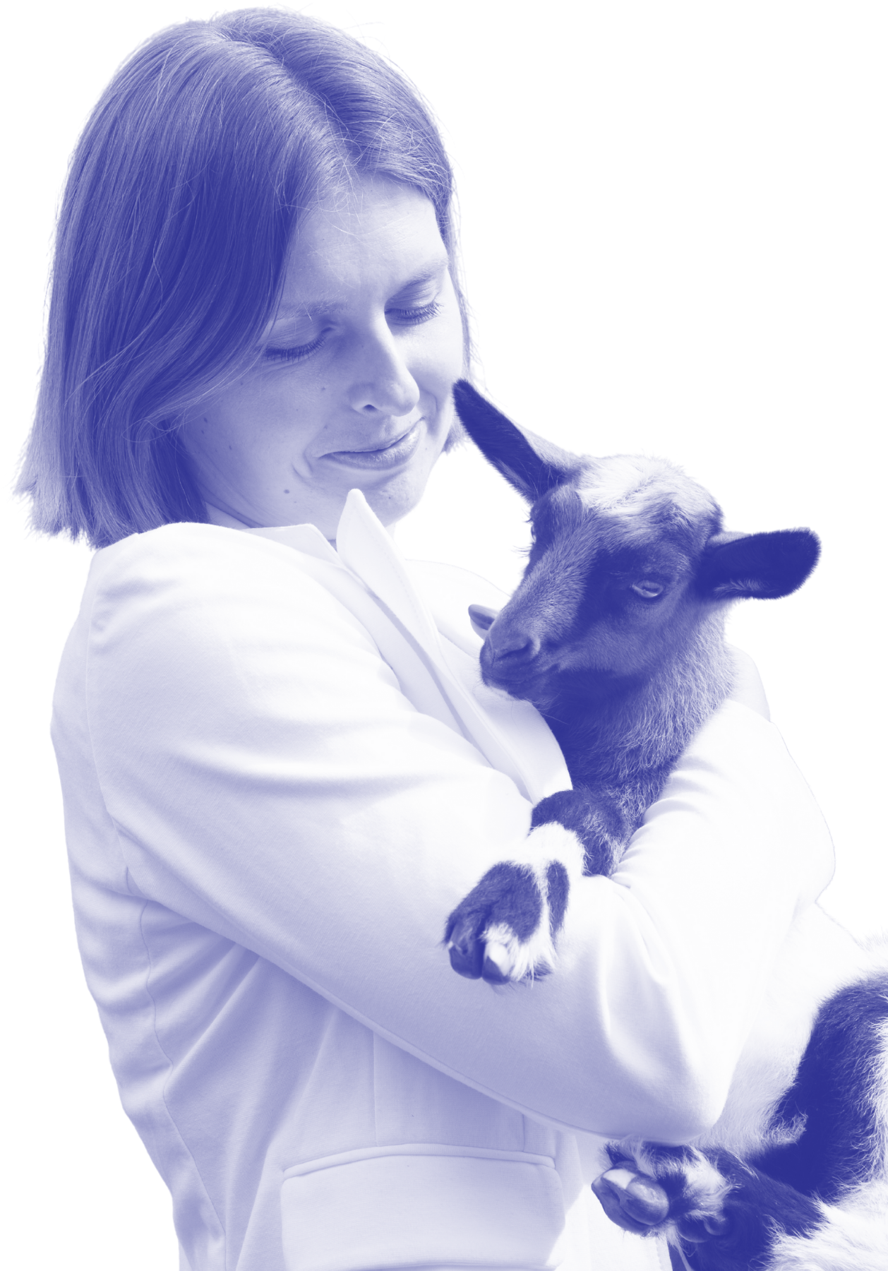 A person gently smiling as they hold a baby goat close