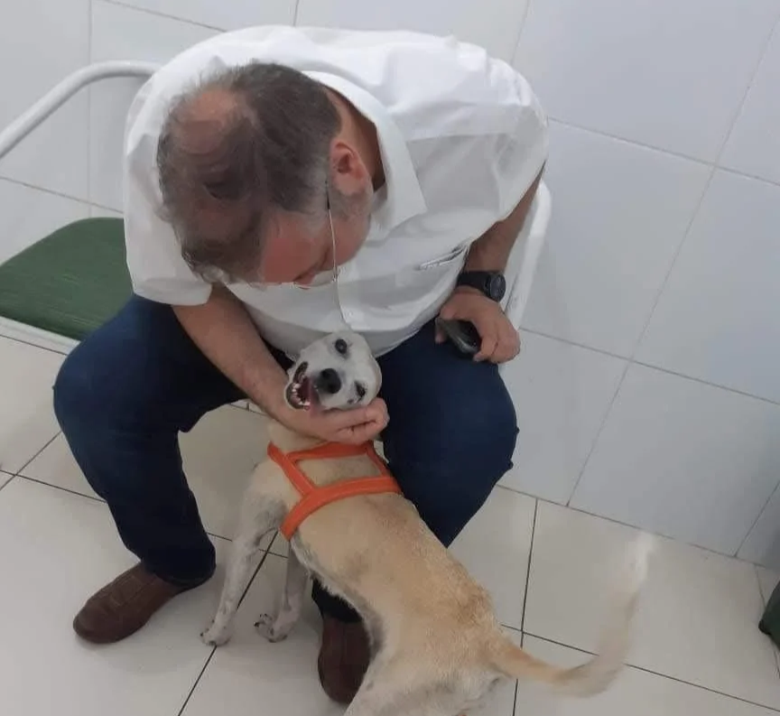 Man embraces happy dog