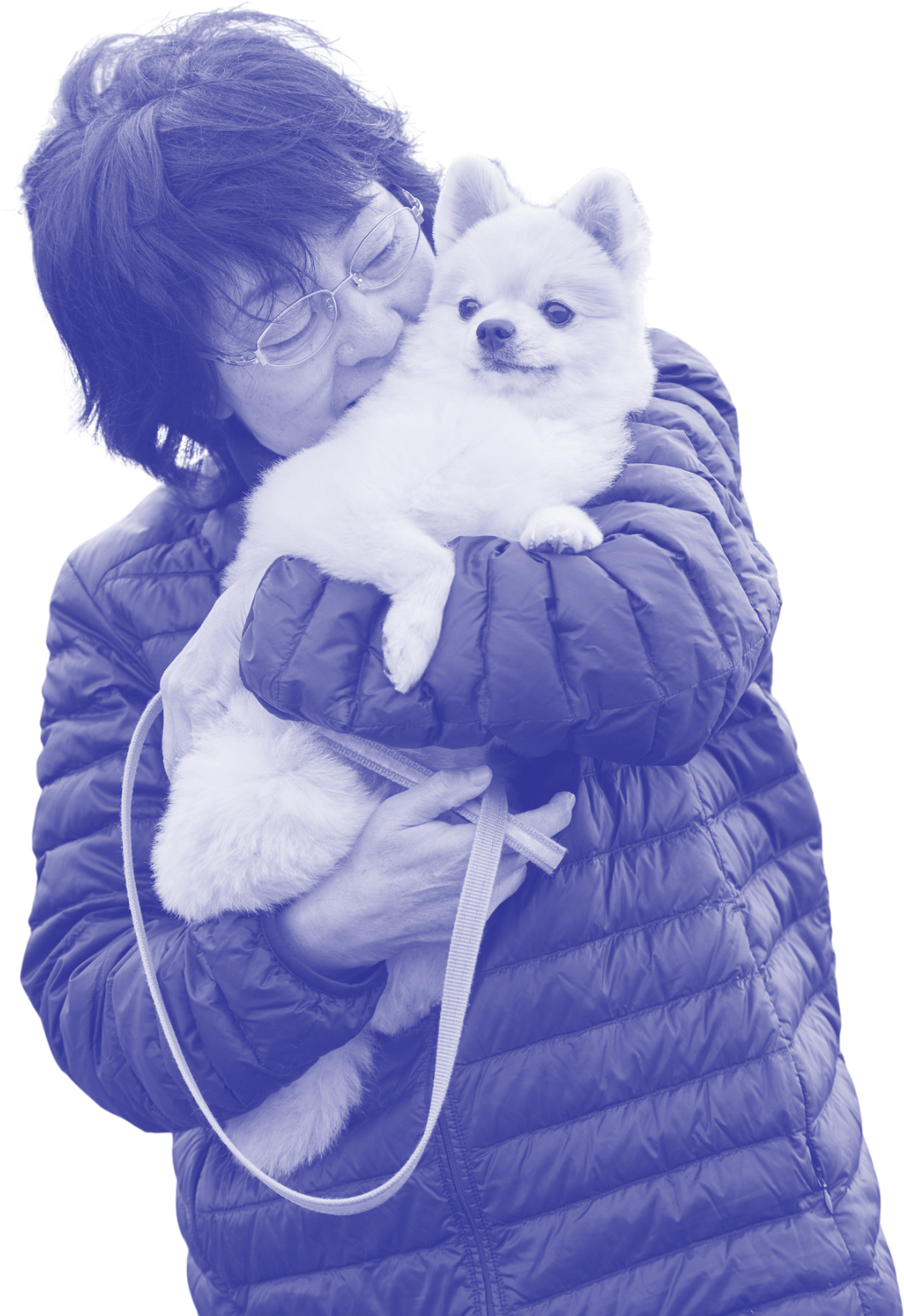 A woman with short hair stands hugging and holding a small white dog
