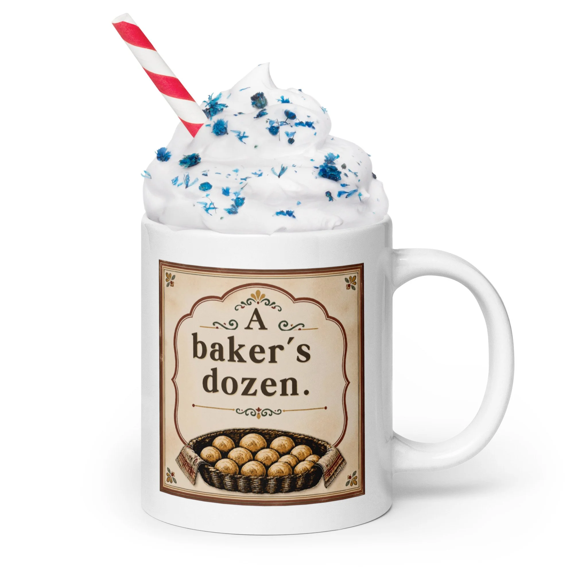 White ceramic mug with “A baker’s dozen” design shown with whipped cream and sprinkles.
