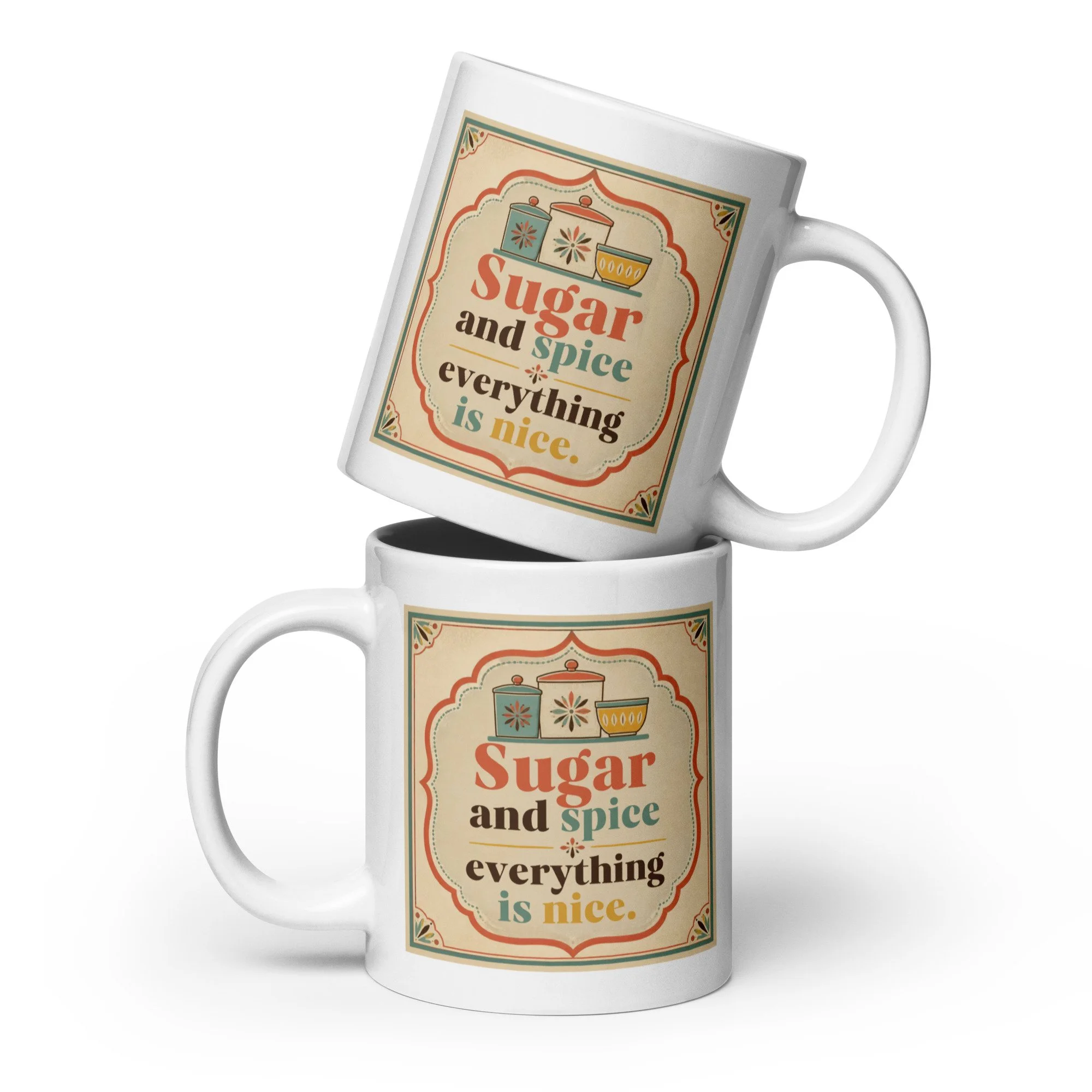 Two stacked white ceramic mugs featuring the “Sugar and spice everything is nice” vintage design.