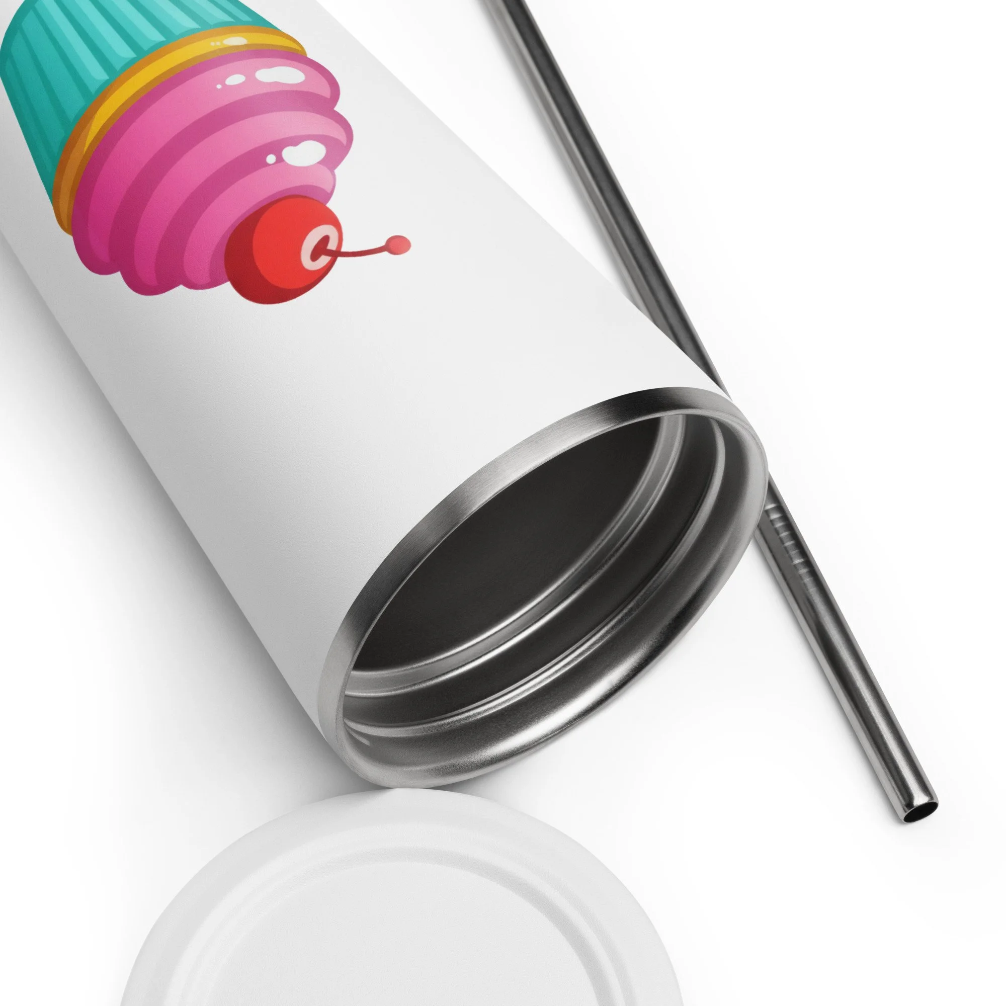 Close-up of the insulated tumbler showing the cupcake with a cherry on top design near the rim with straw beside it.