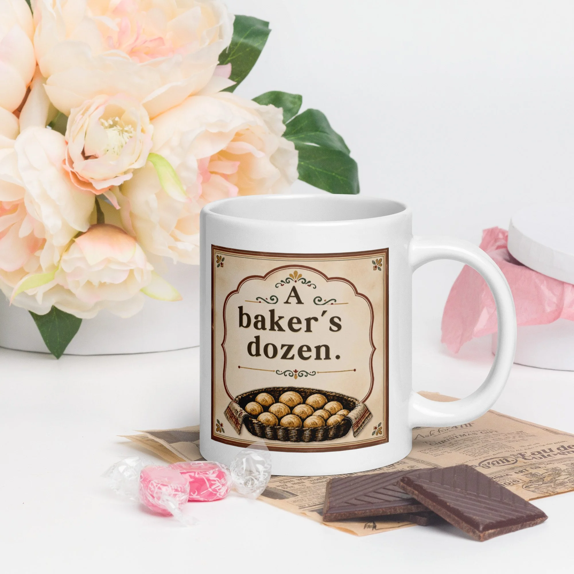 Lifestyle photo of the “A baker’s dozen” mug on a tray with flowers and treats.