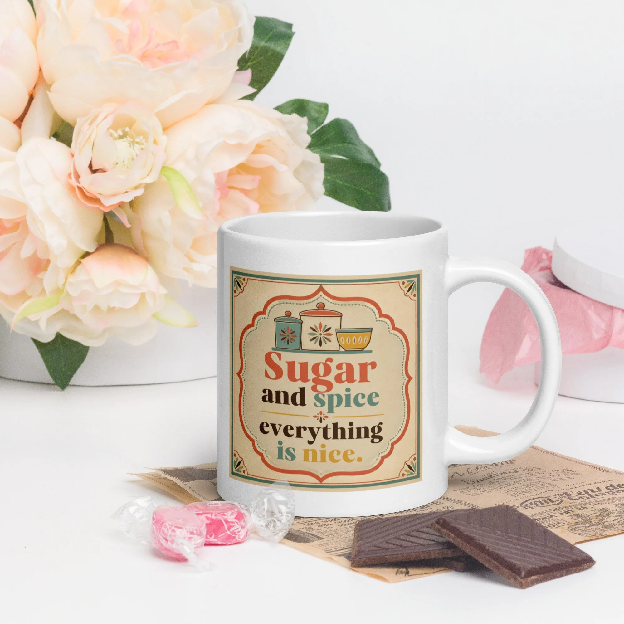 Lifestyle photo of the “Sugar and spice everything is nice” mug on a tray with flowers and treats.