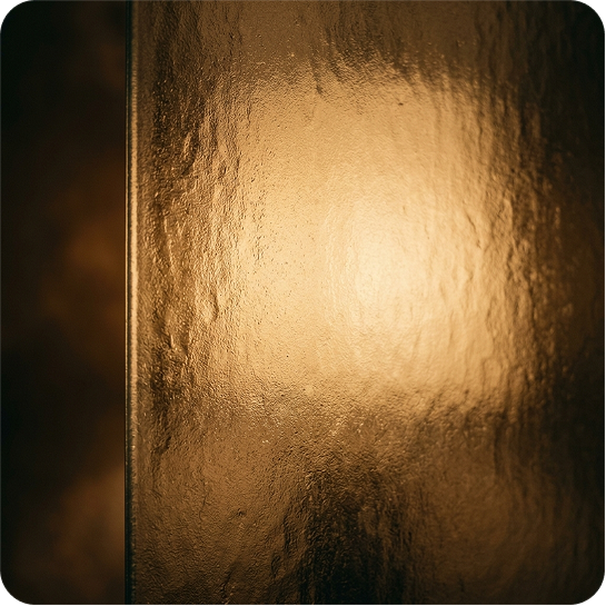 Close-up of a metallic gold surface with a textured, reflective finish.