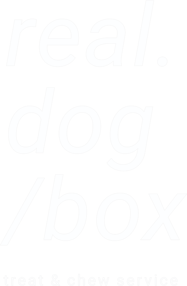 The image displays white text on a black background that reads 'real.dog/box' with the smaller text below stating 'treat & chew service'.
