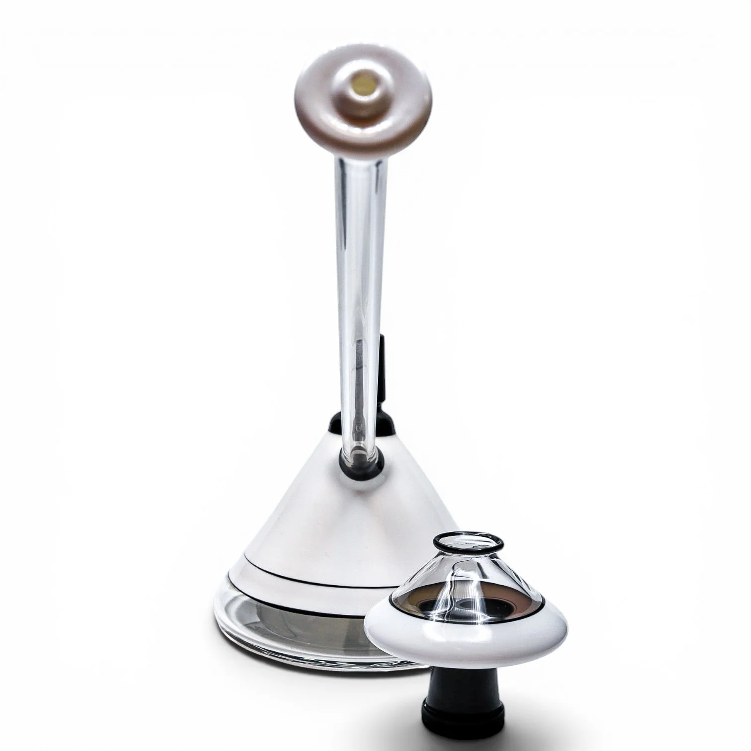 Glass equipment with a conical base, a tube extending upward, and a small glass container nearby, all on a white background.