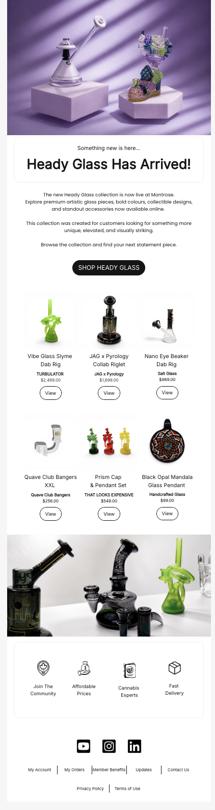 Display of colorful artistic glass pieces, including dab rigs and pendants, on white pedestals with promotional text for a new glass collection.