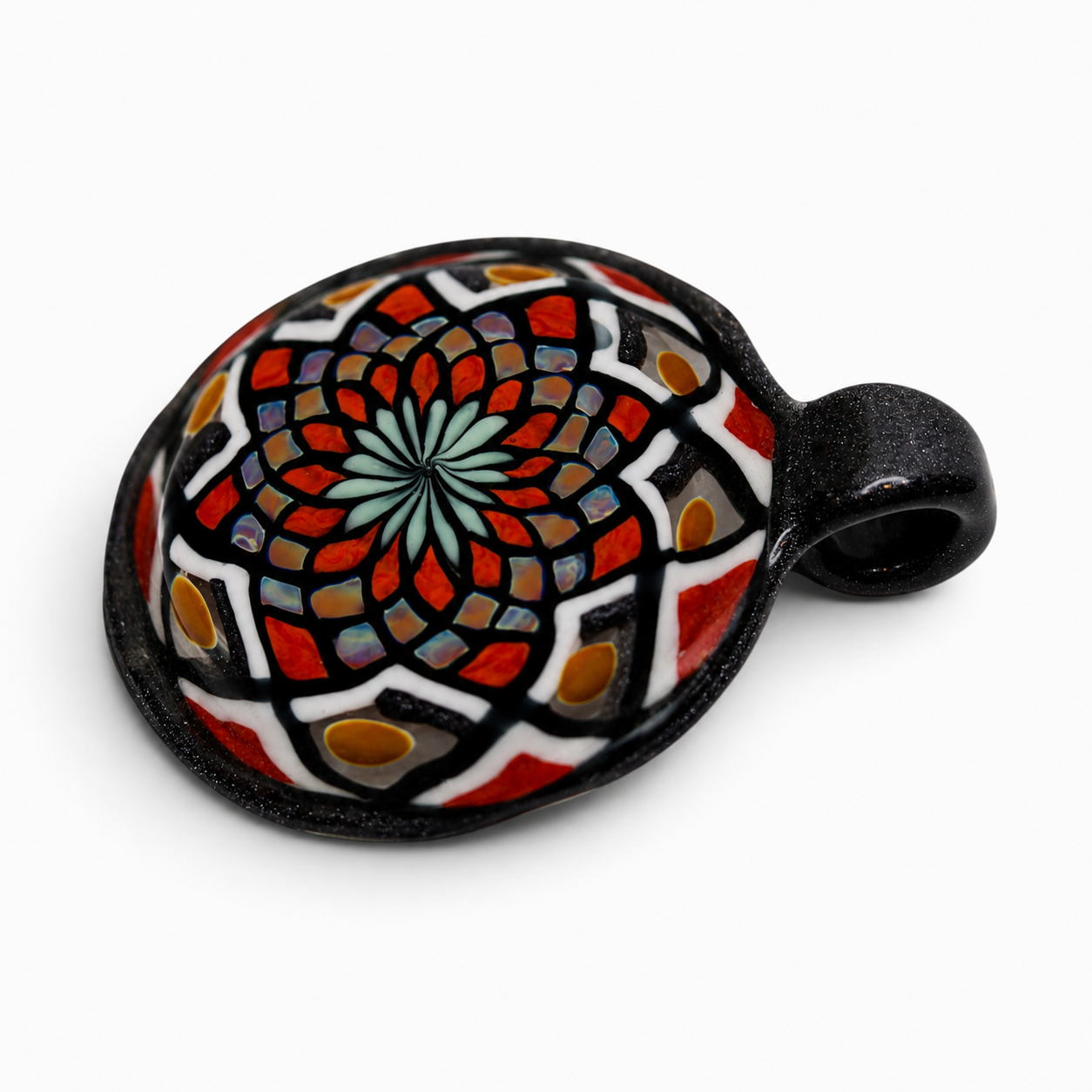 Colorful decorative glass turtle with intricate mosaic pattern in red, blue, yellow, black, and white on a white background.