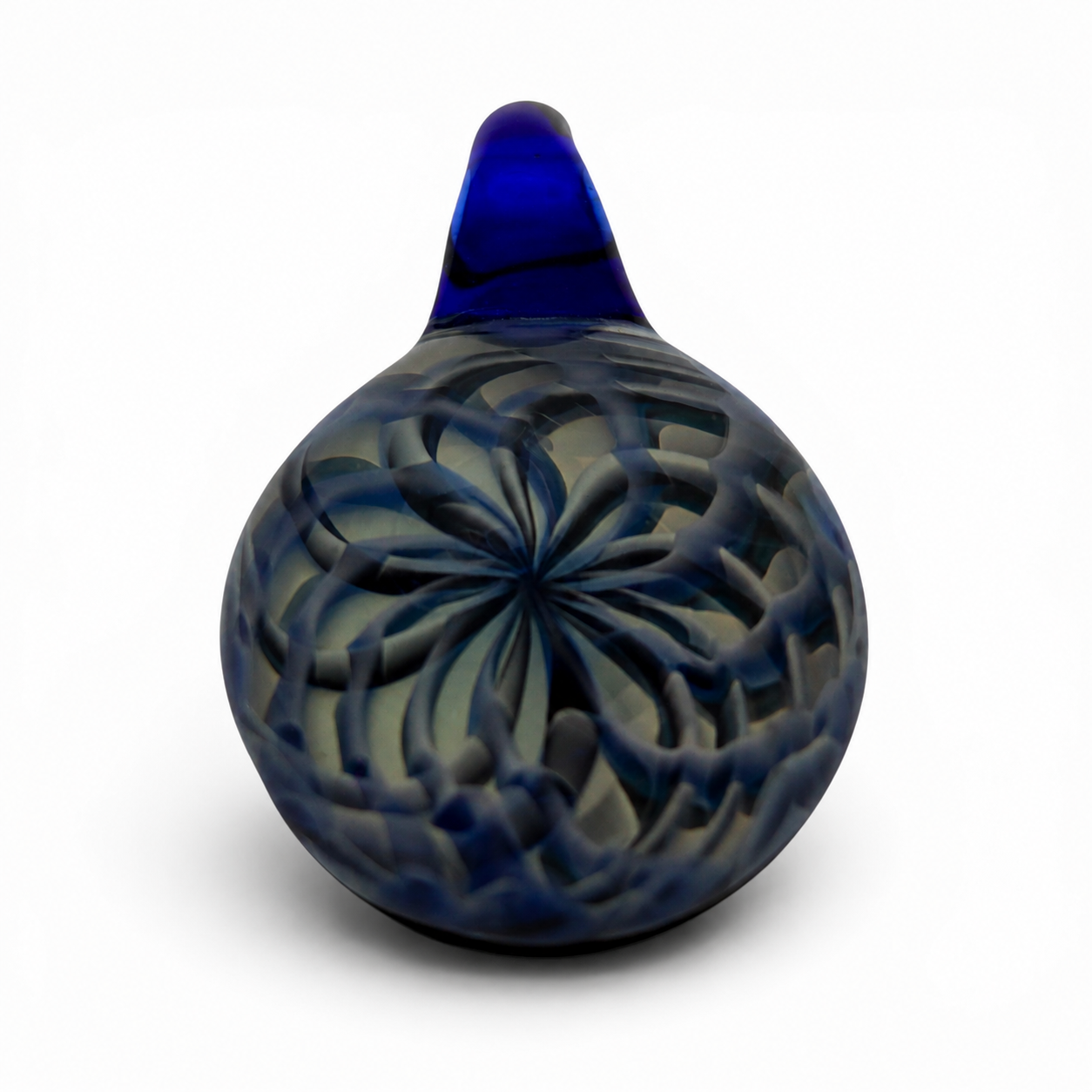 Blue and white glass paperweight with intricate floral or star pattern design inside