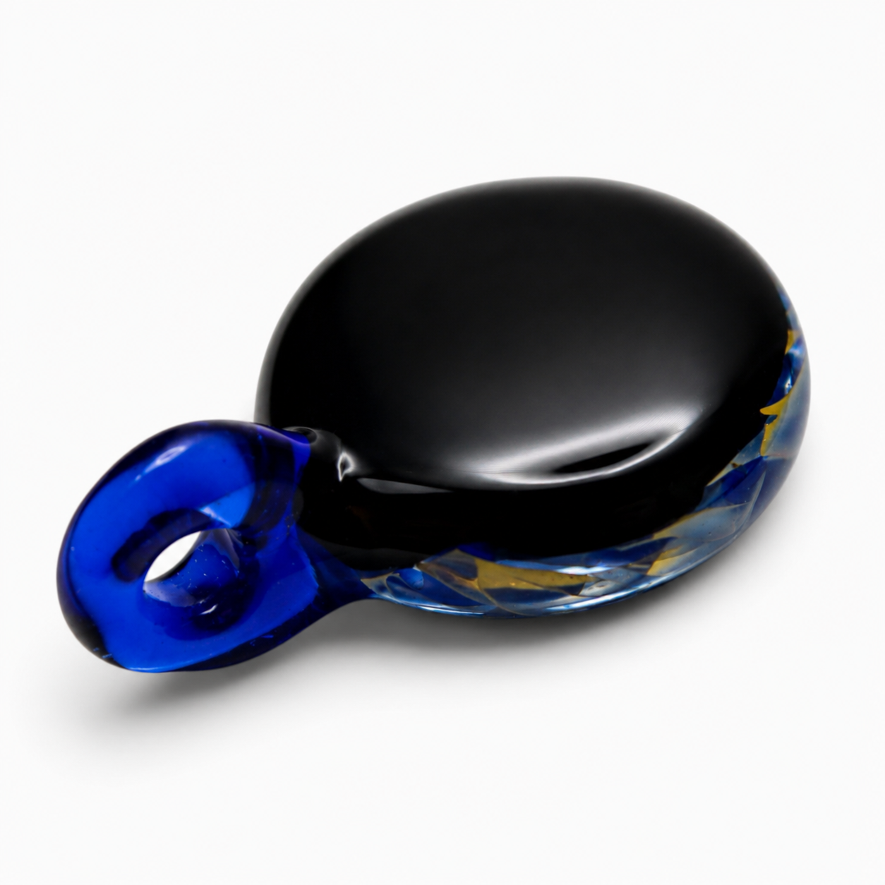 A decorative glass bowl with a black interior and a blue and gold exterior, featuring a blue glass handle on one side.