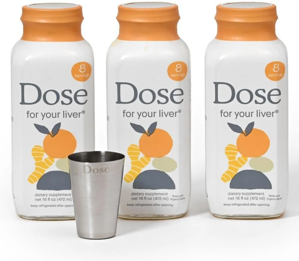 Three bottles of Dose dietary supplement for your liver, each with an orange cap, and a metal shot glass in front of the bottles. The bottles are labeled as containing eight servings.