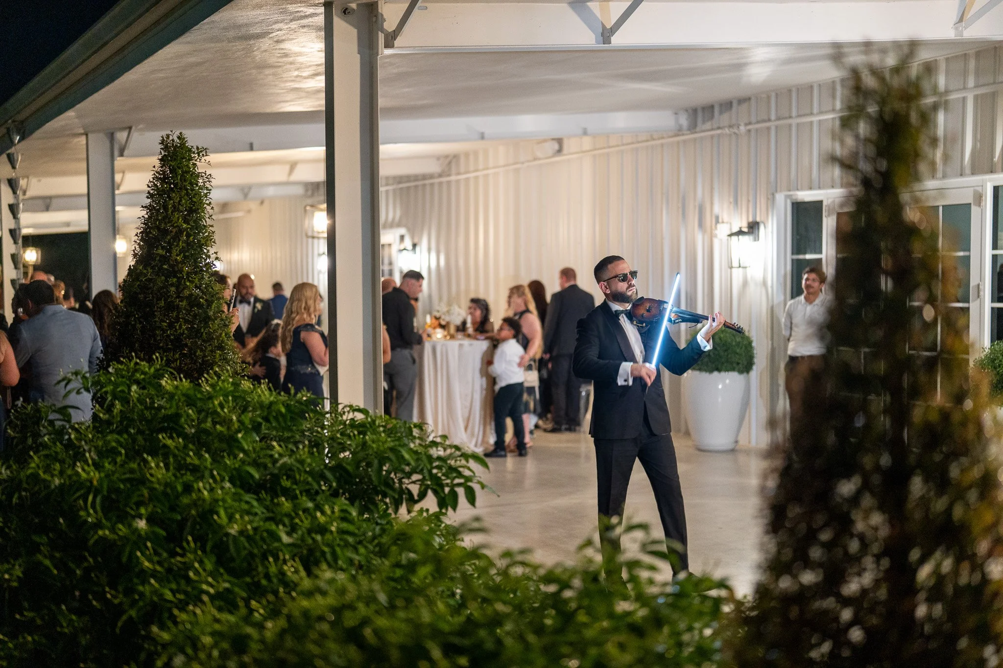Guests enjoying live violin during cocktail hour at The White Orchid in Miami