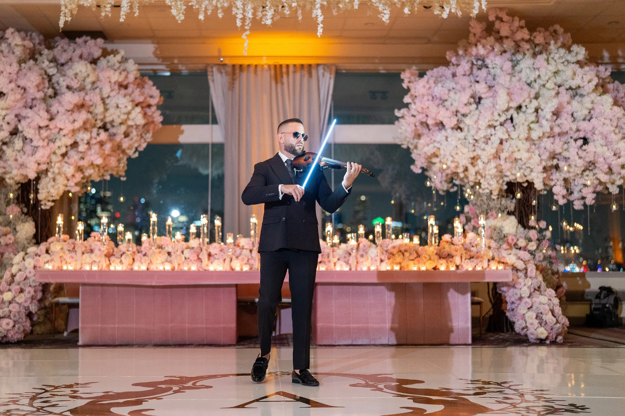 Violinist performing during a quinceañera reception at Rusty Pelican in Miami