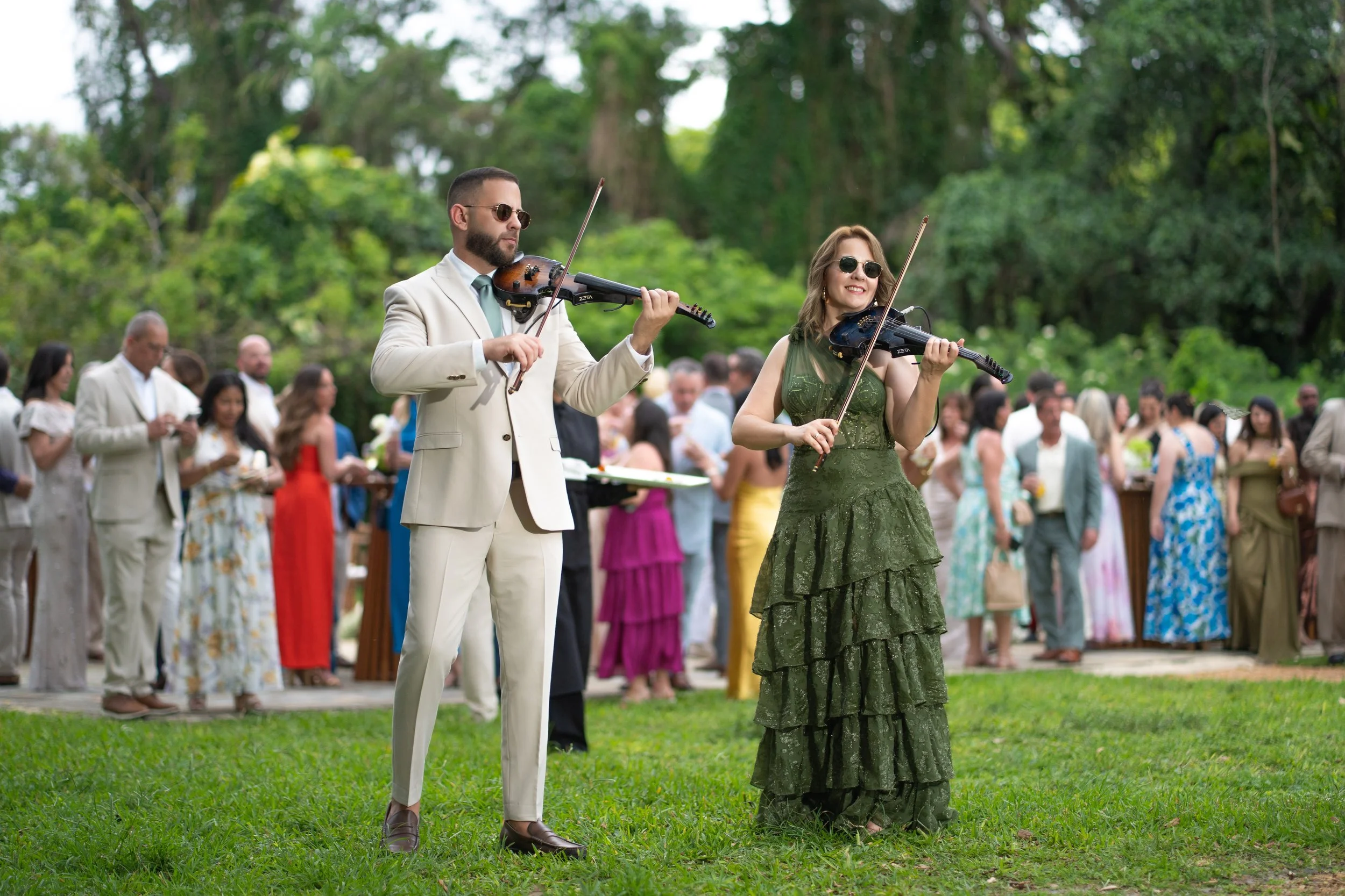 Violinists performing during cocktail hour at The Ancient Spanish Monastery wedding