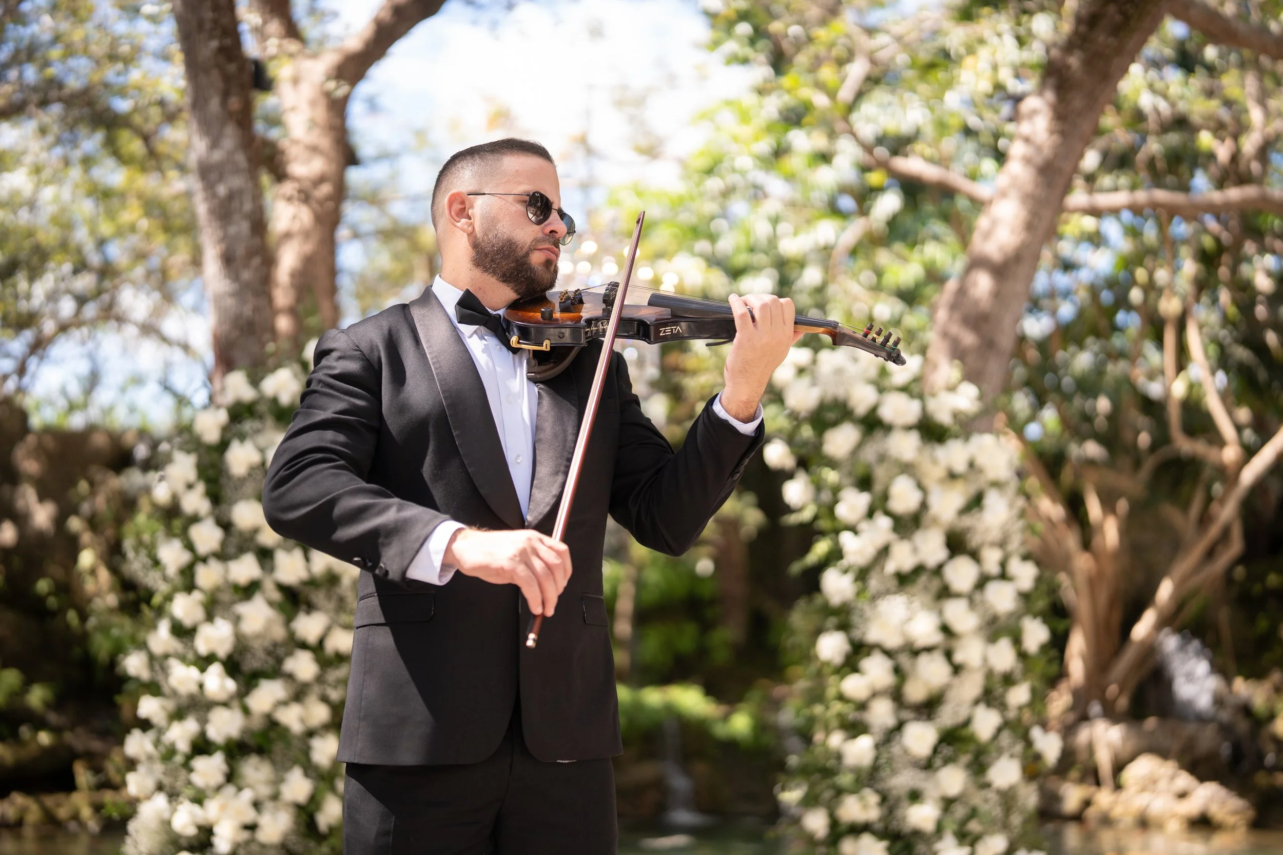 Wedding ceremony violinist in Miami performing live violin music during an elegant outdoor wedding ceremony.