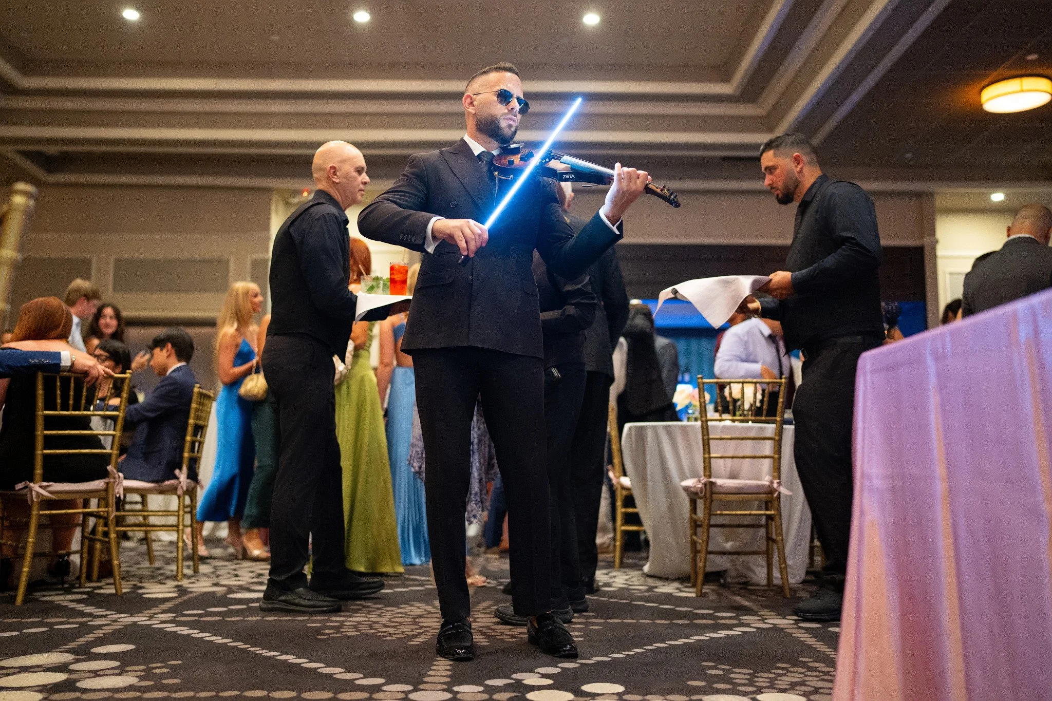 Violinist performing during cocktail hour at a quinceañera at Rusty Pelican in Miami