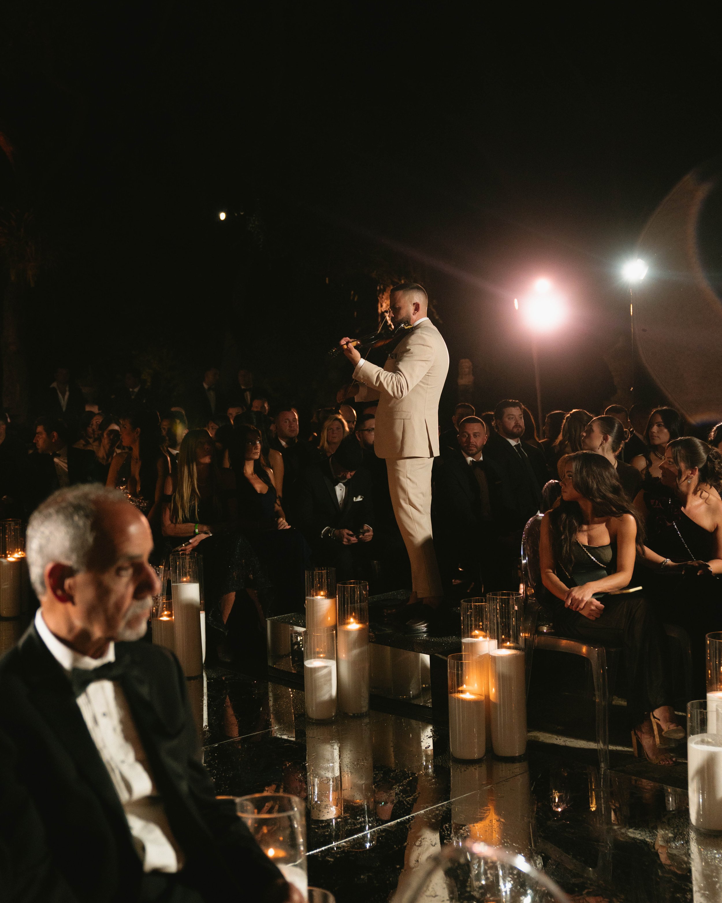 Wedding violinist performing live among guests at a luxury wedding in Vizcaya Museum & Gardens