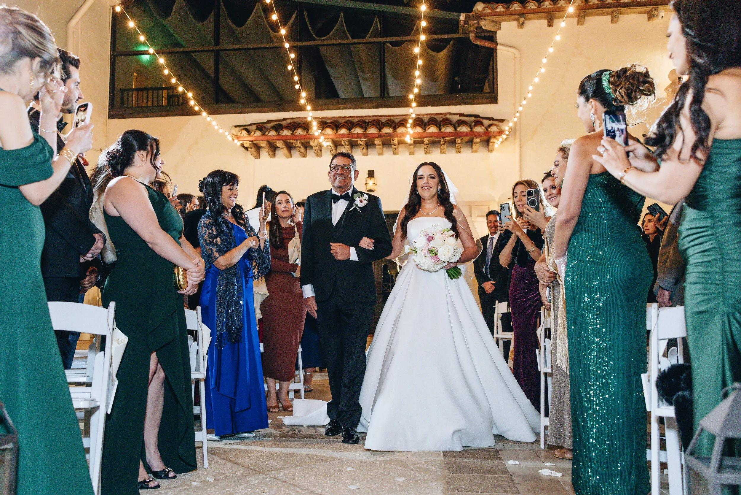Bride entrance during outdoor wedding ceremony at The Addison Boca Raton with live violin music