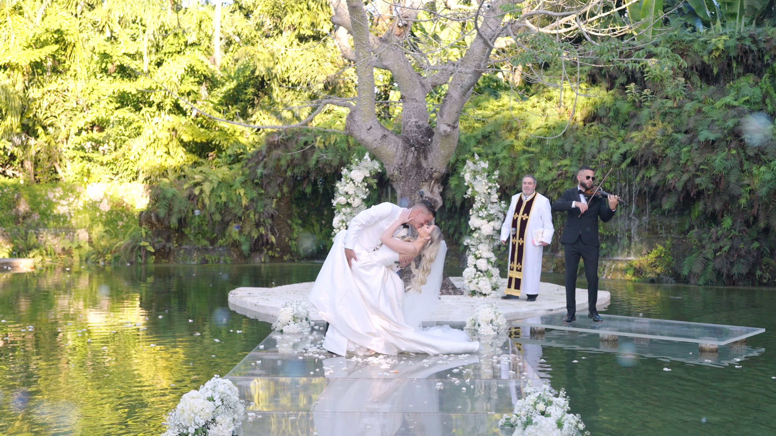 First kiss during wedding ceremony at Fica Farms in Miami with live violin music