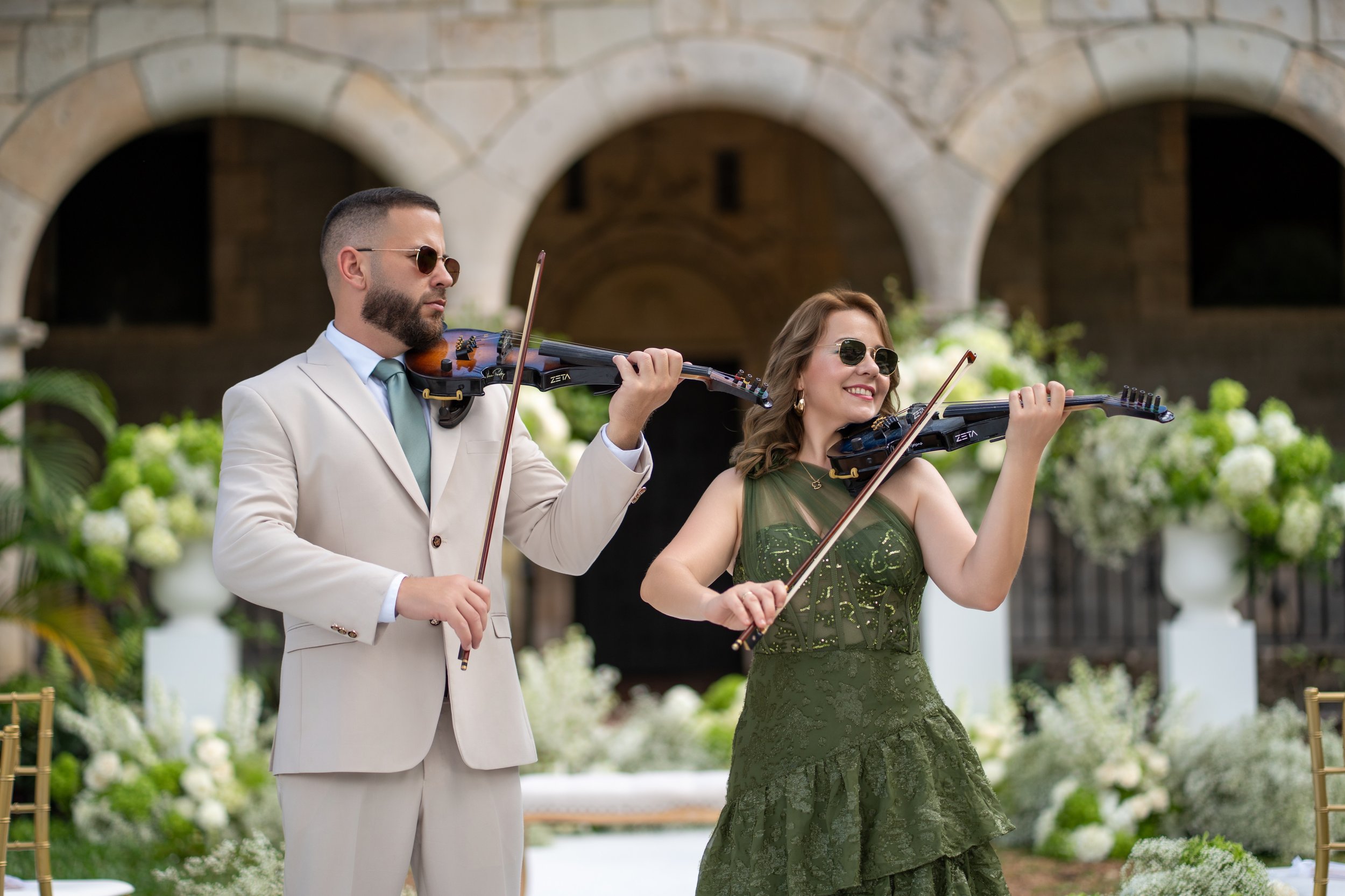 Violin duo performing during wedding ceremony at The Ancient Spanish Monastery