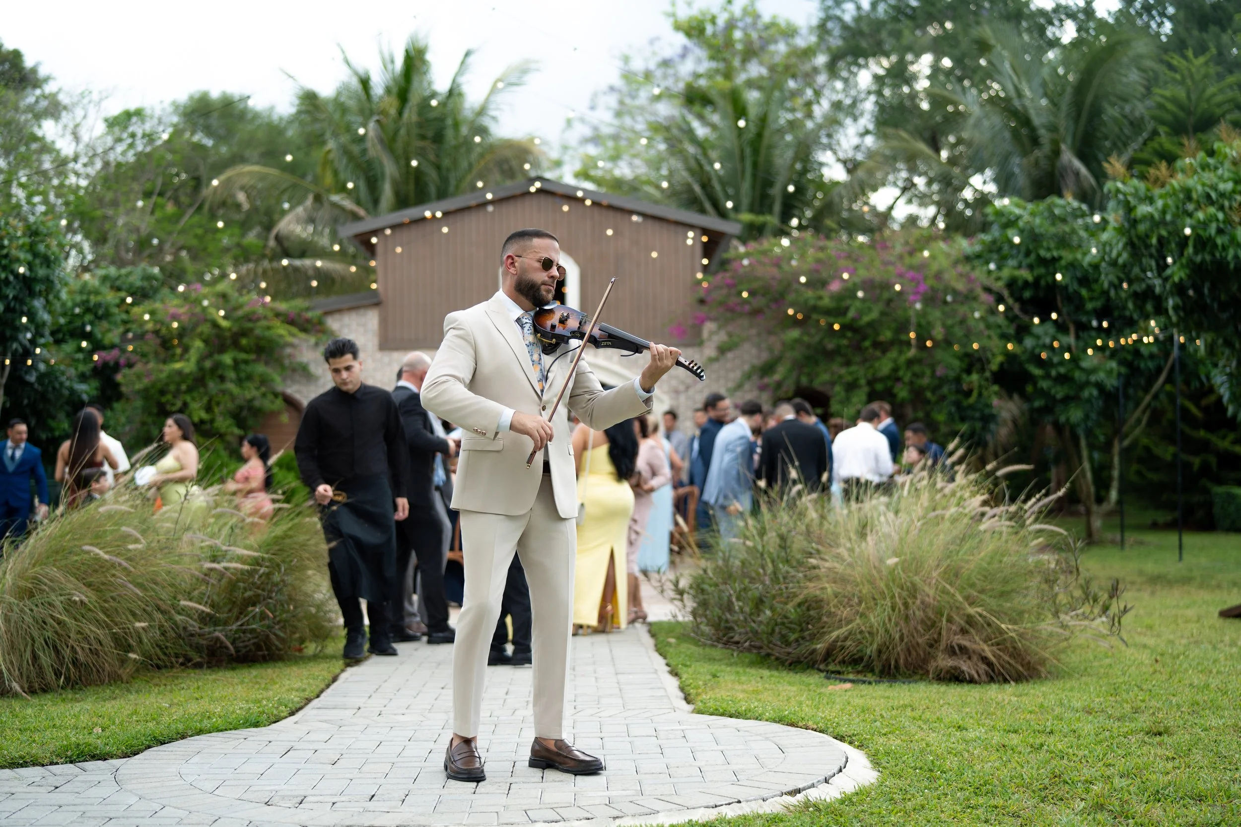 Wedding cocktail hour violinist performing live at Cinco Farm Gardens in Miami