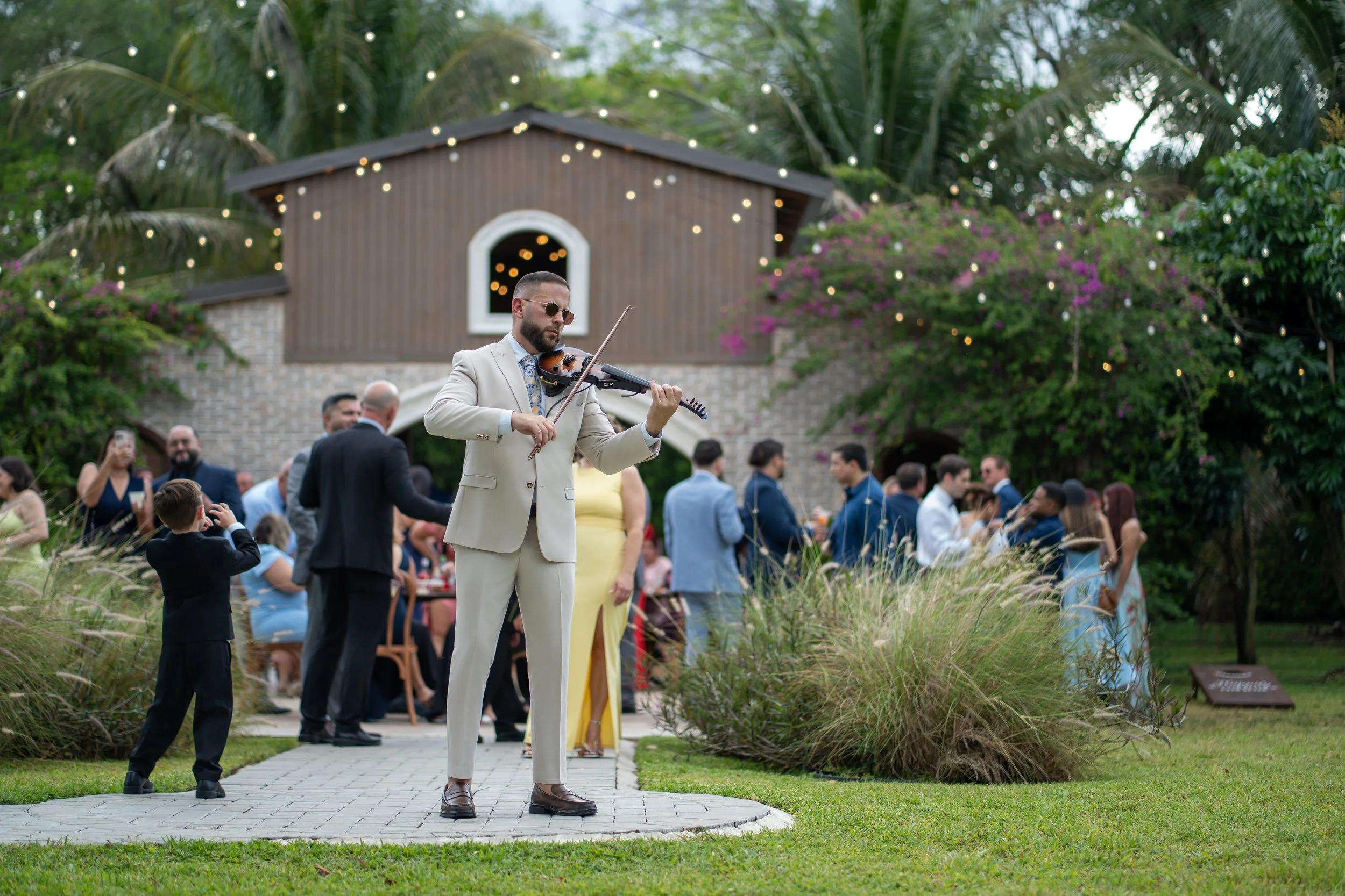 Miami wedding violinist performing during cocktail hour at Cinco Farm Gardens
