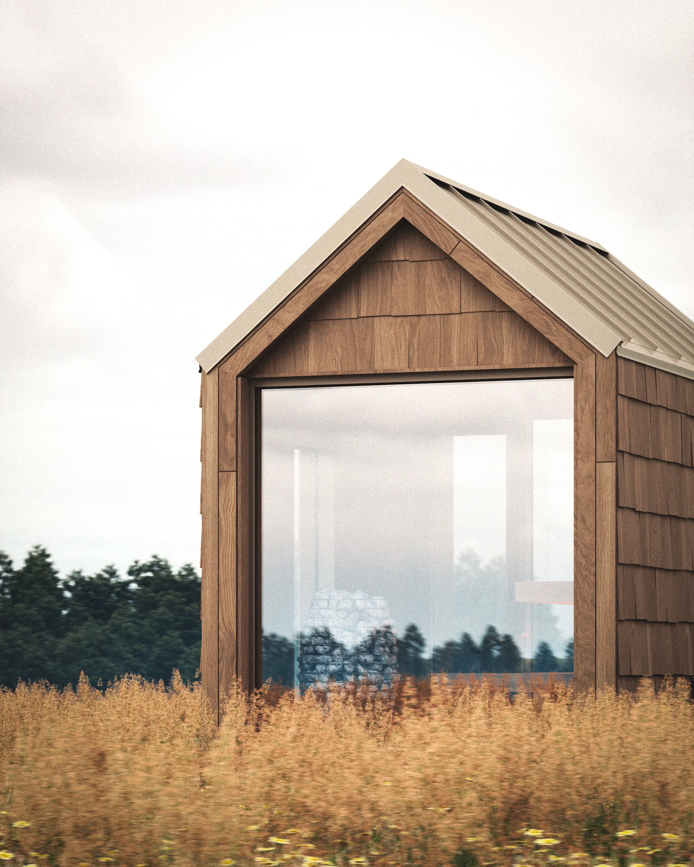 A small wooden house with a large glass window in a field of tall grass, with trees and an overcast sky in the background.