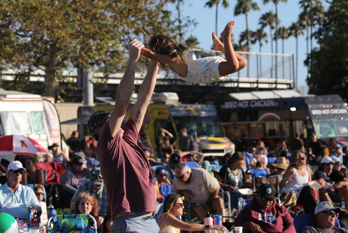 People enjoying a summer evening at costa mesa concert in the park series.