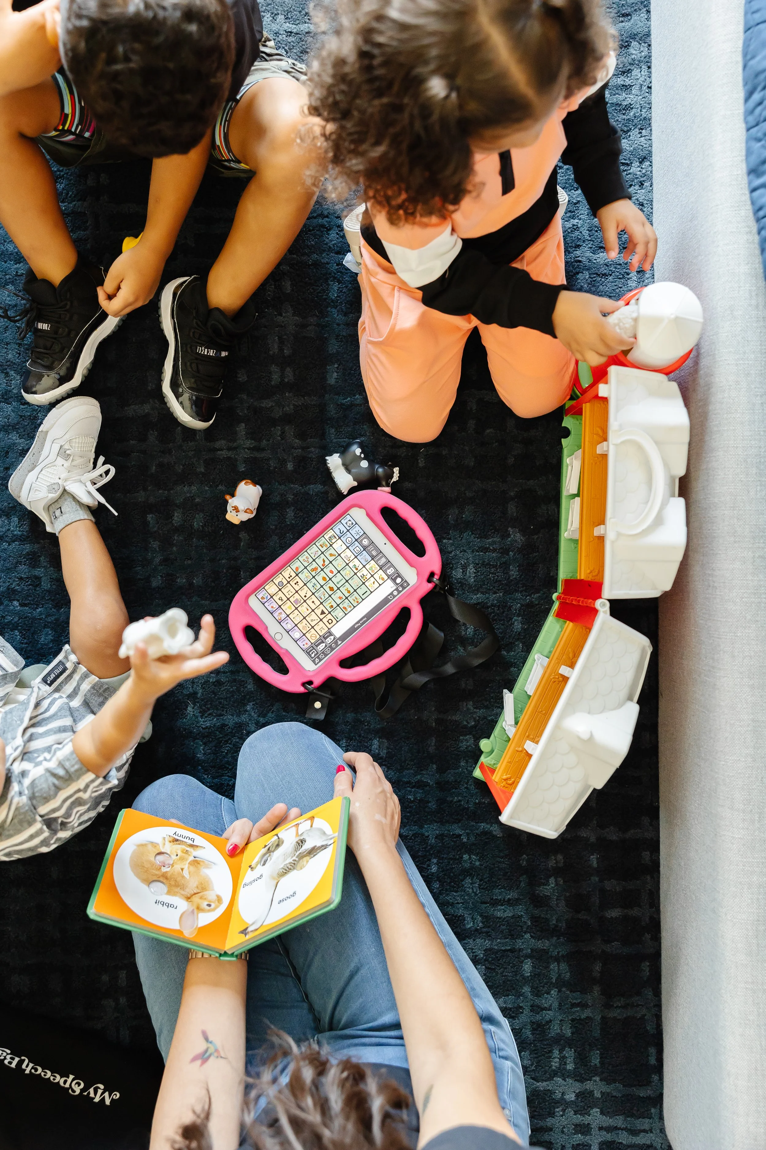 children receiving speech and language therapy in Georgia with Haynes Therapy Group. Childrne are using AAC devices to communiate