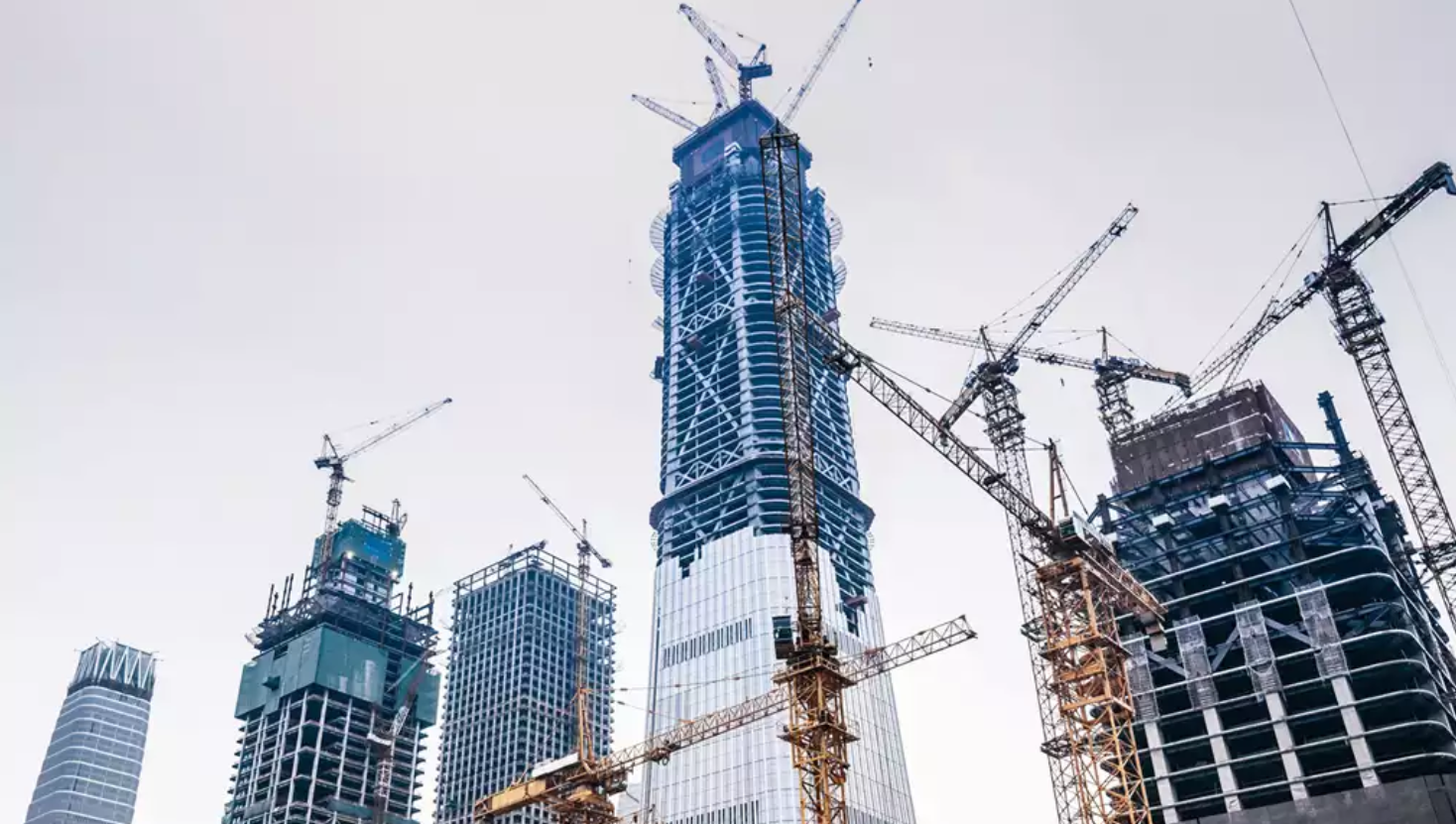 Construction site with multiple skyscrapers and several tower cranes.