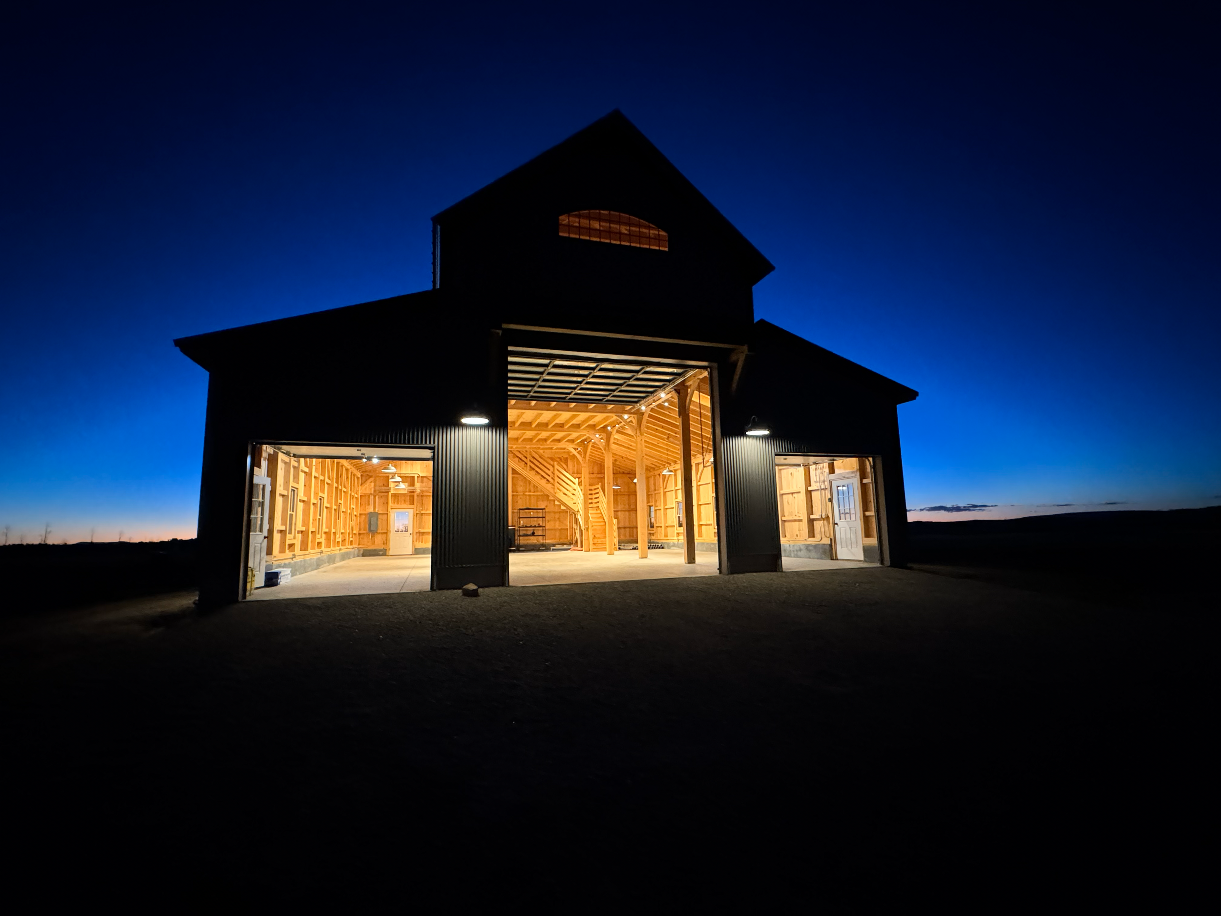 Barn at night with all doors open
