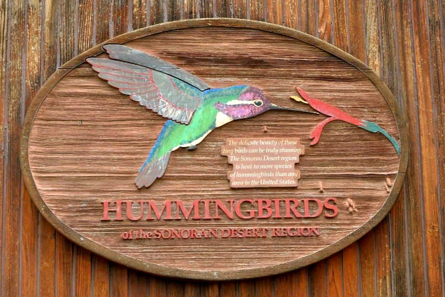 Painted, engraved wooden sign.