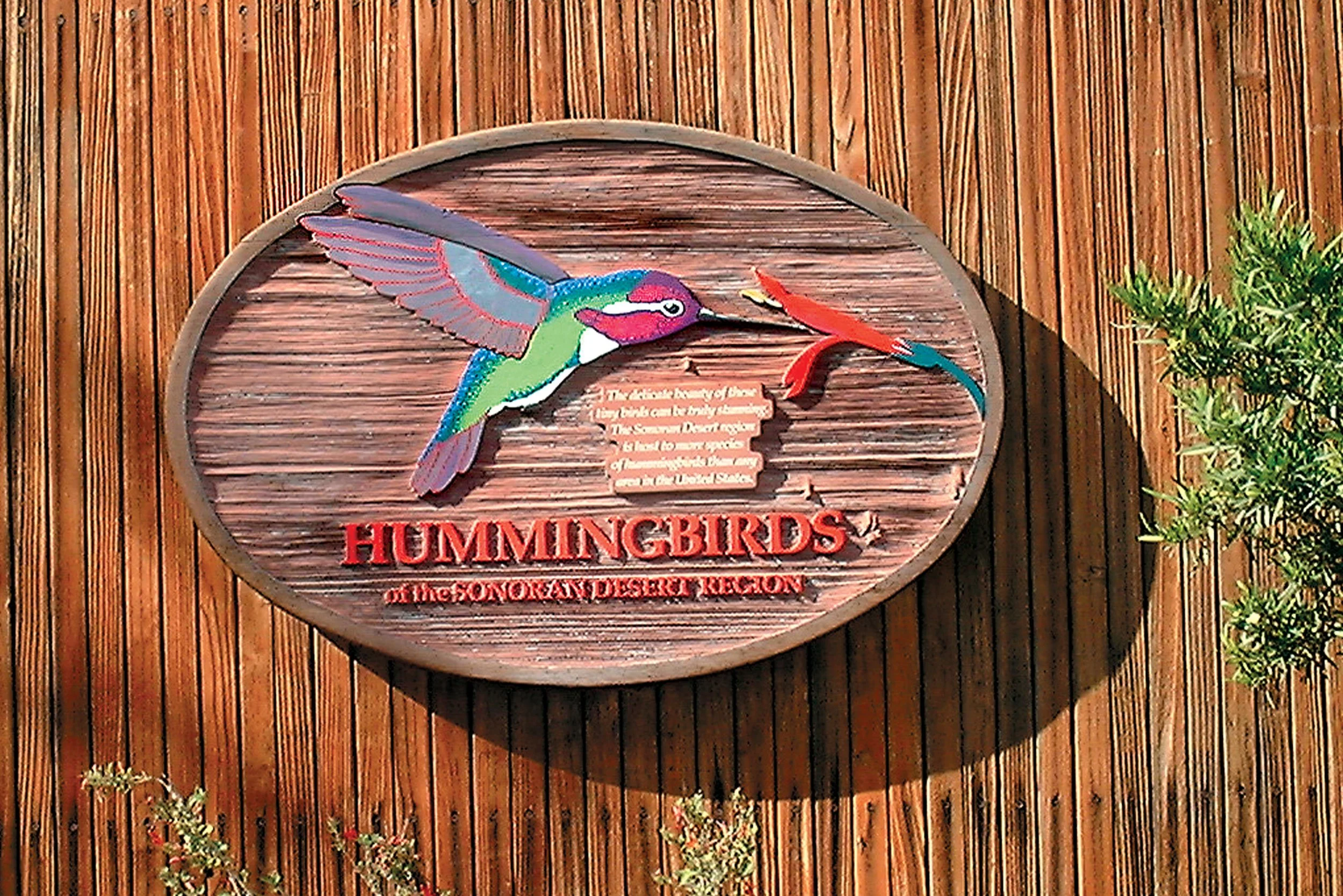 Painted, engraved wooden sign.