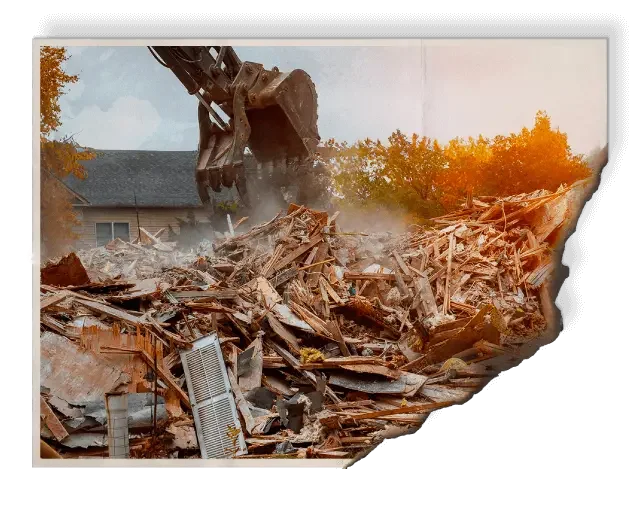 Excavator demolishing hurricane-damaged building at sunset in Pinellas County showing devastation without impact-rated windows and doors in Tampa Bay residential and commercial properties