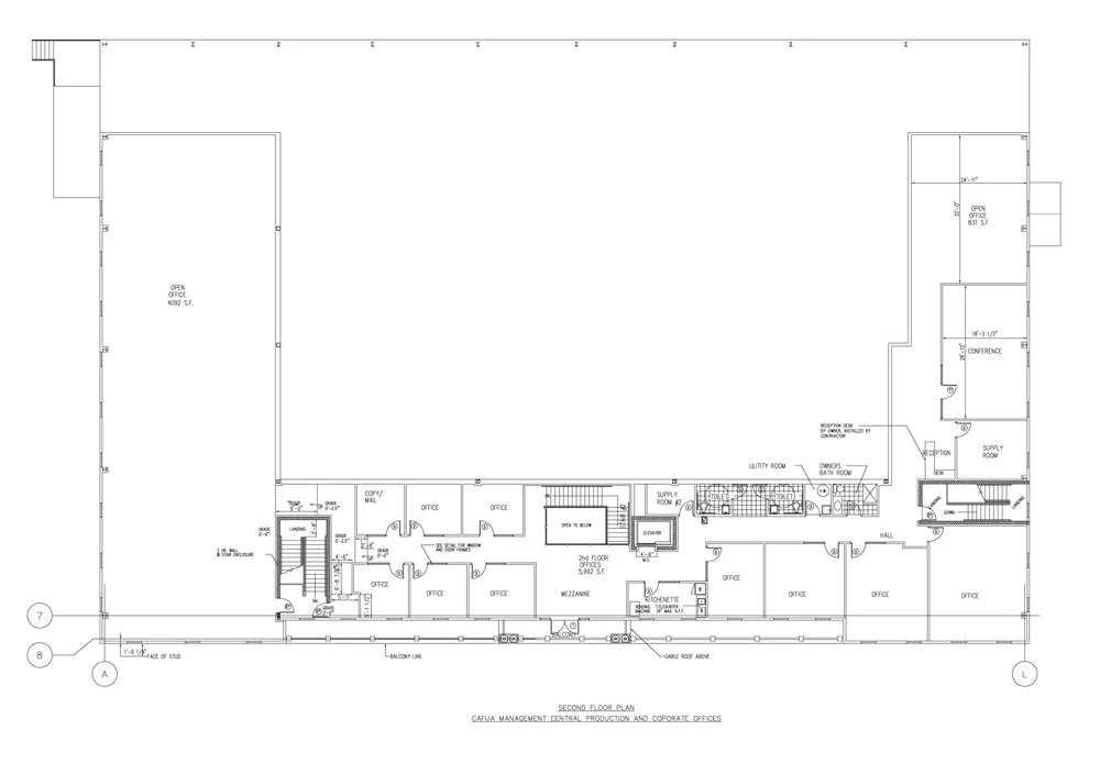 A detailed architectural floor plan drawing of a building, showing various rooms including offices, conference rooms, restrooms, and an open office space.