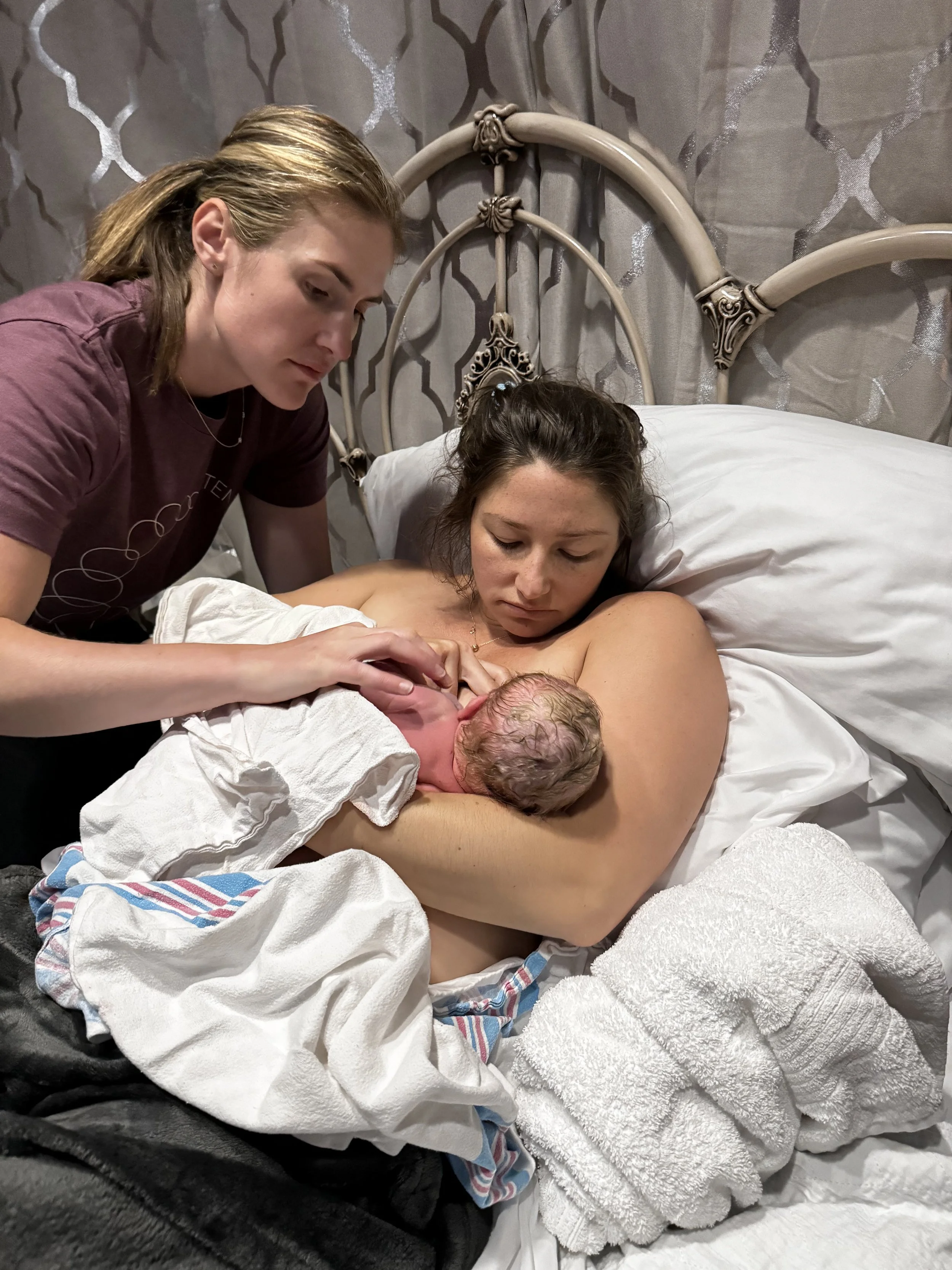 doula helping in golden hour with breastfeeding baby