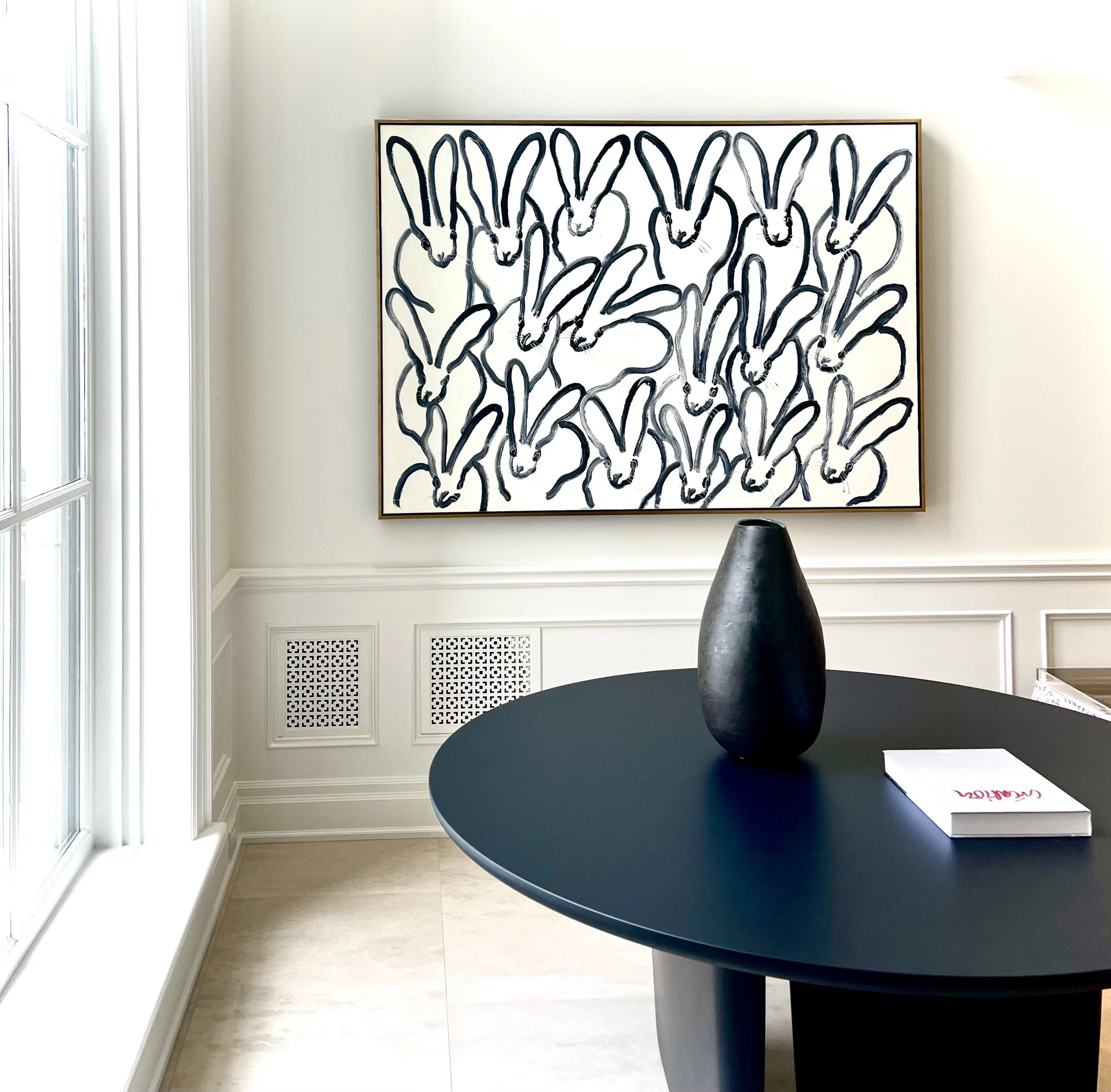 Hunt Slonem New York artist artwork, black and white bunnies, set in a high end space with sculpture