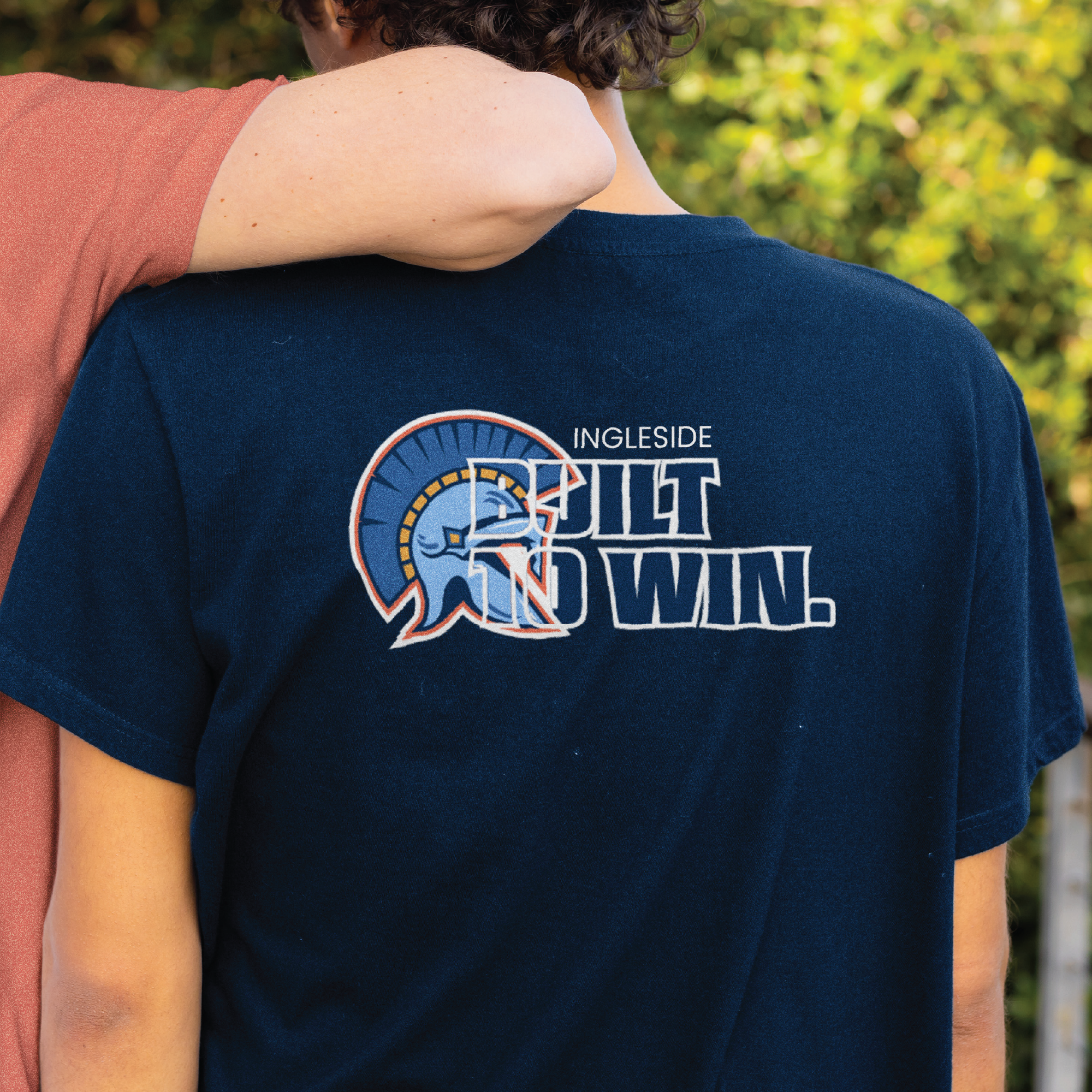 Back print design applied to apparel, combining bold typography and mascot elements to reinforce school spirit.